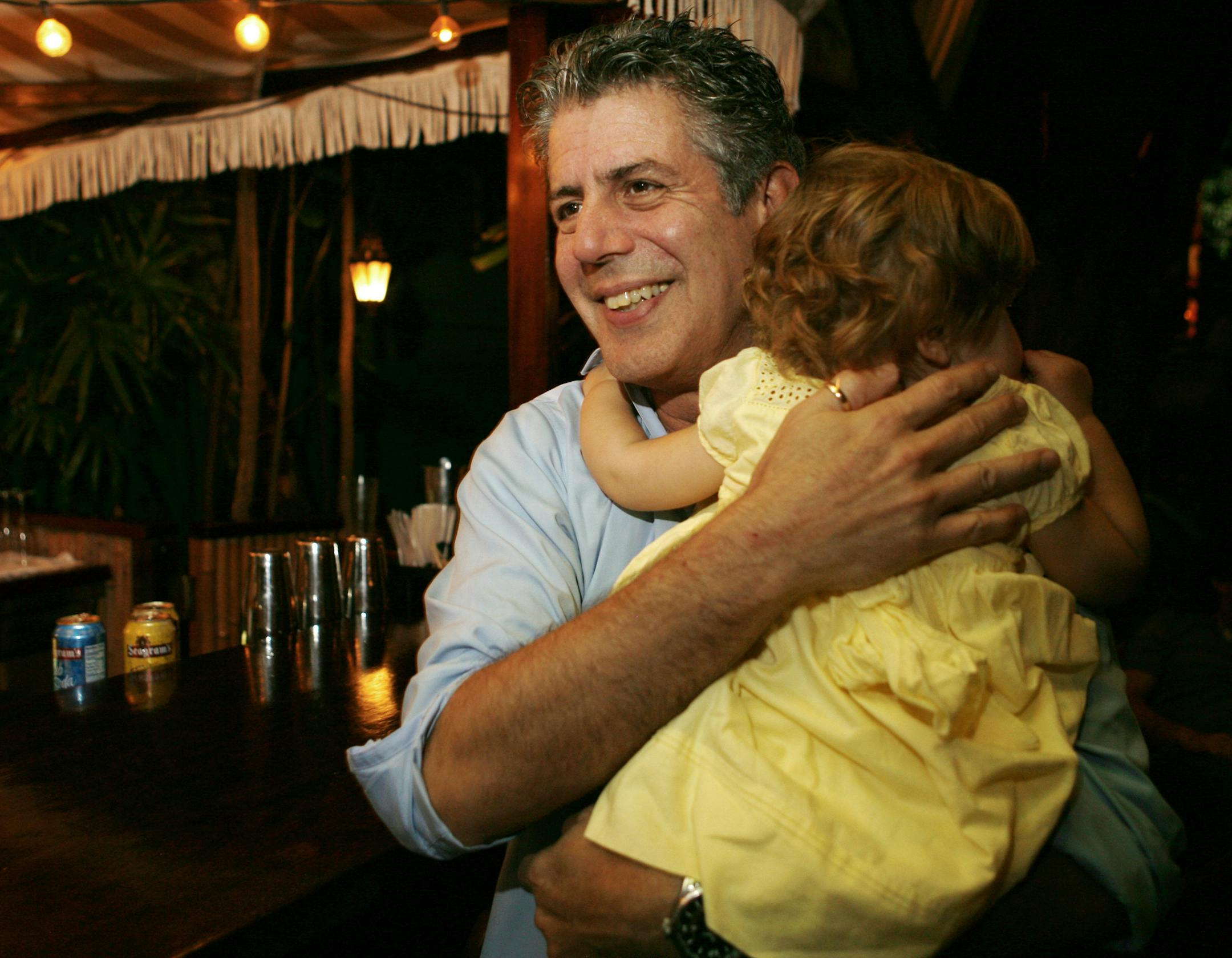 FILE - In this Nov. 12, 2008 file photo, Chef Anthony Bourdain holds his daughter Ariane in Miami Beach. Court papers show that Bourdain was worth $1.2 million when he died last month. Most of the estate has been left to his daughter, who is now 11-years-old. Bourdain was found dead June 8 in an apparent suicide in his French hotel room while working on his CNN series "Parts Unknown." (AP Photo/Lynne Sladky, File)