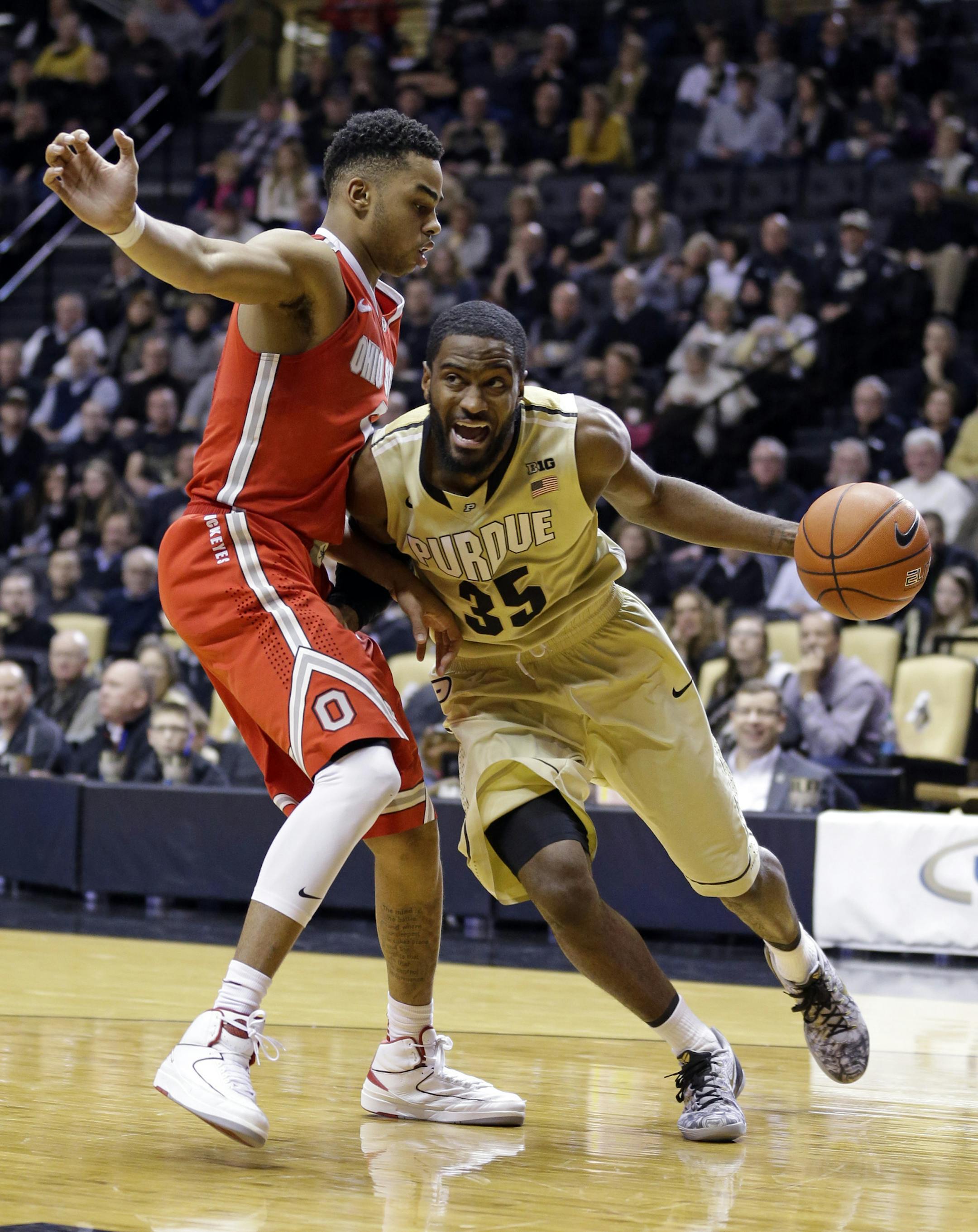 Purdue guard Rapheal Davis (35) drives on Ohio State guard D'Angelo Russell (0) in the second half of an NCAA college basketball game in West Lafayette, Ind., Wednesday, Feb. 4, 2015. Purdue defeated Ohio State 60-58. (AP Photo/Michael Conroy)