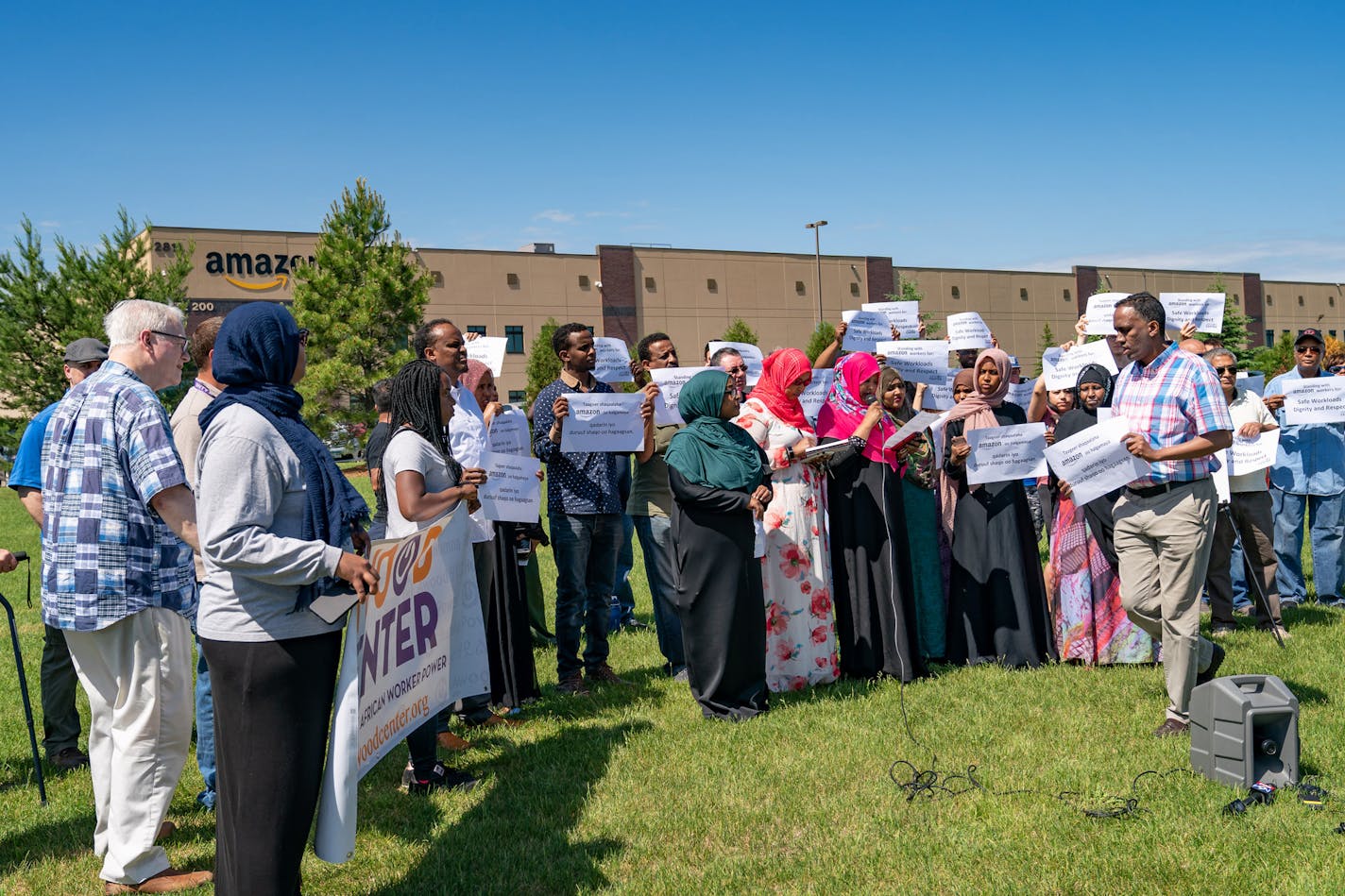 Workers protested outside of an Amazon facility in Eagan, complaining about working conditions. They signed a card with a list of demands and tried to deliver it to the building management.