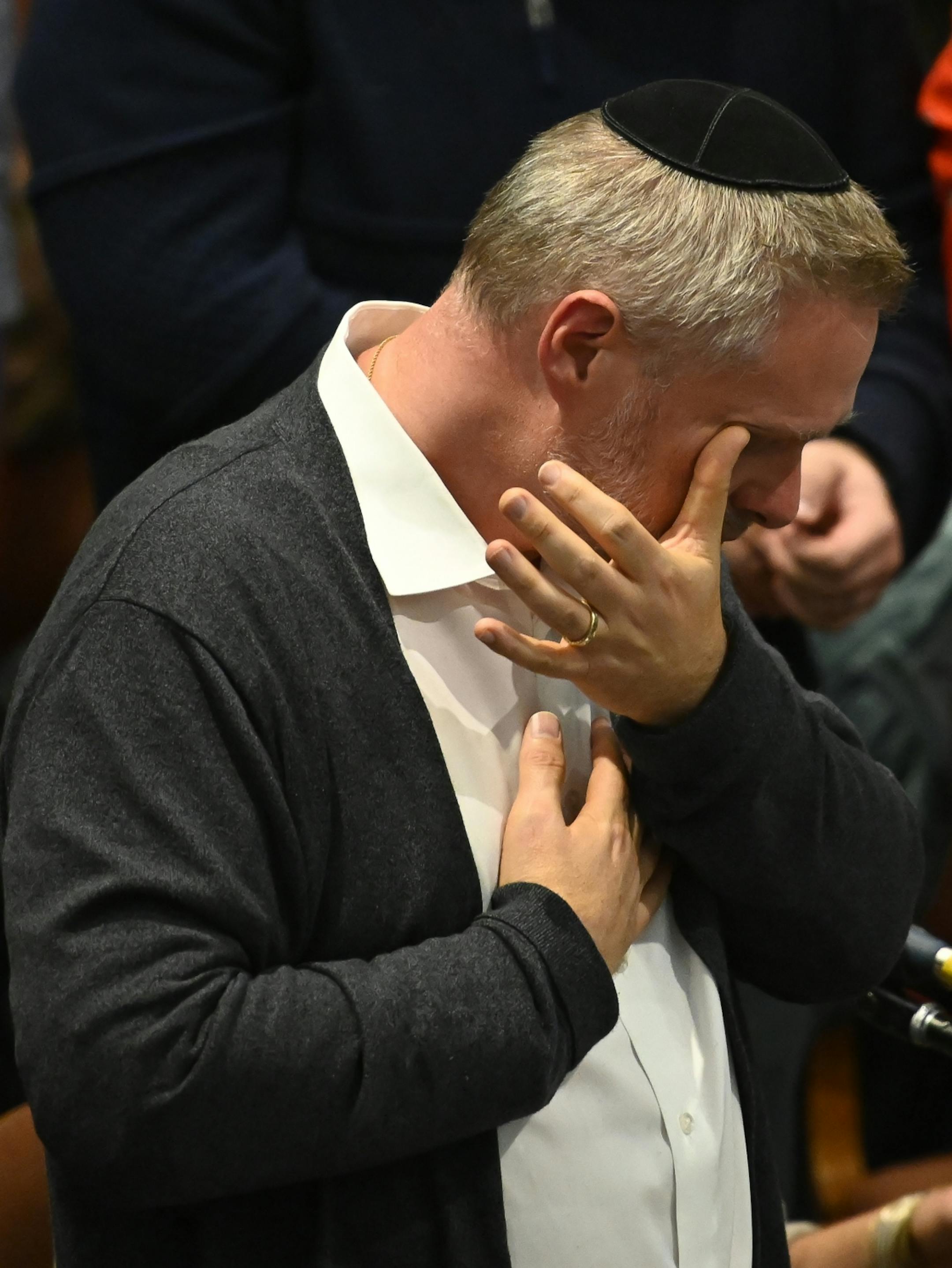 Rabbi Michael Adam Latz wiped tears from his eyes before the start of Friday night's sabbath services at Shir Tikvah.
