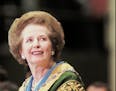 Former British Prime Minister Margaret Thatcher smiles as the audience gives her a standing ovation before her commencement address at William and Mar