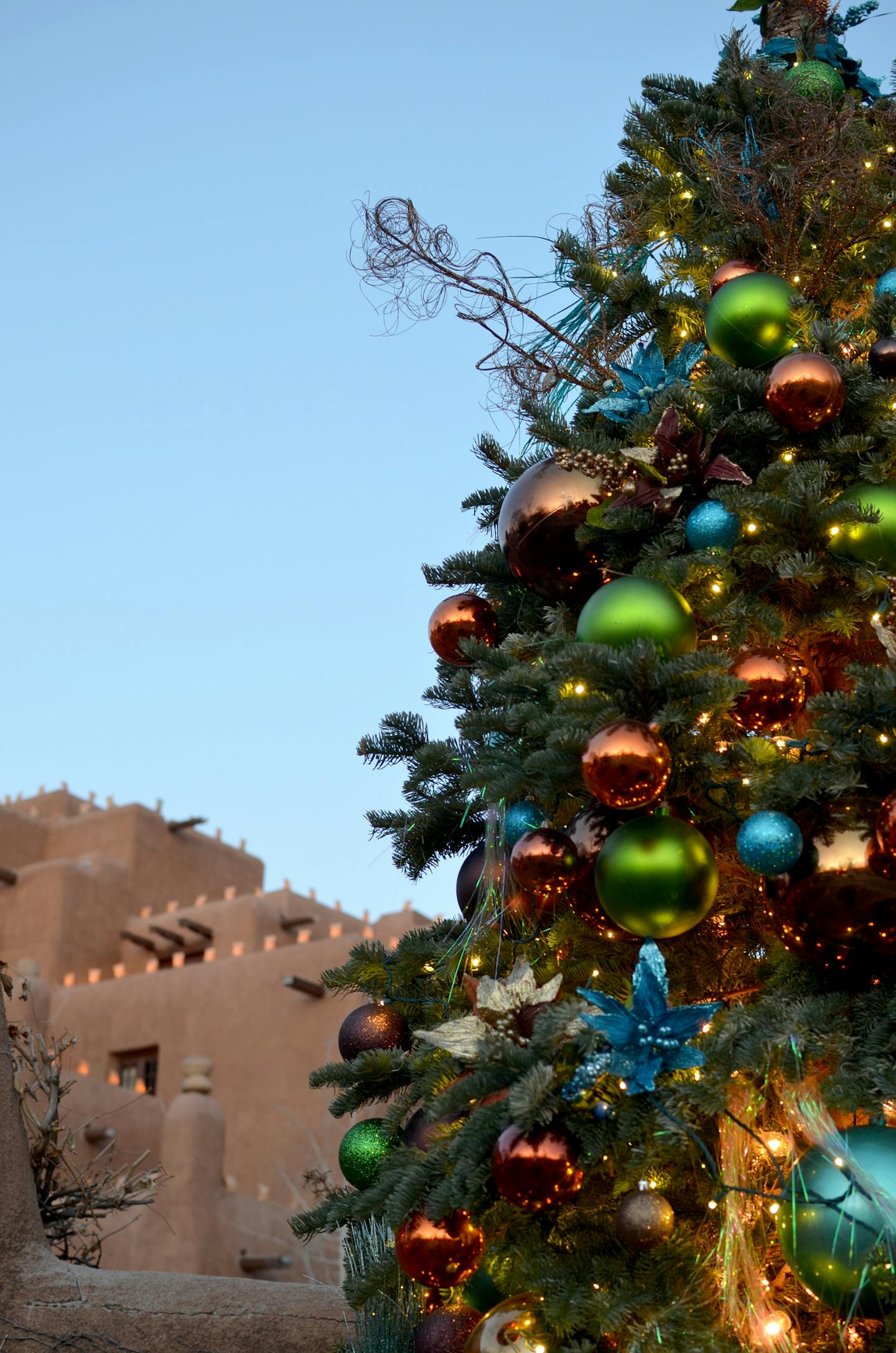 During holiday time in Santa Fe, adobe buildings are outlined with farolitos (the luminous little bags filled with sand and candles, also called luminaries). Photo credit: Donna Tabbert Long