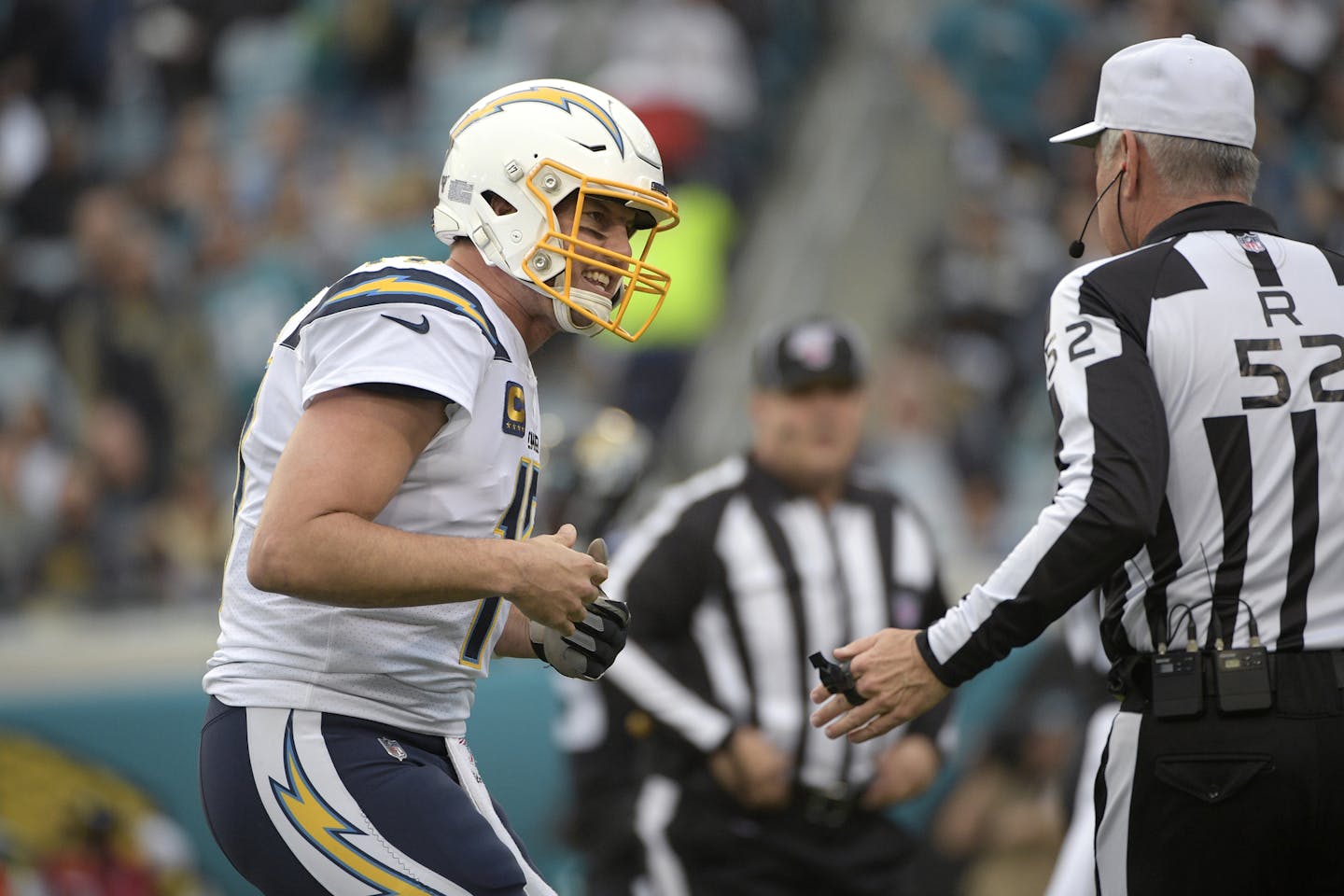 Los Angeles Chargers quarterback Philip Rivers, left, talks with referee Bill Vinovich (52) after a play during the first half of an NFL football game against the Jacksonville Jaguars Sunday, Dec. 8, 2019, in Jacksonville, Fla. (AP Photo/Phelan M. Ebenhack)