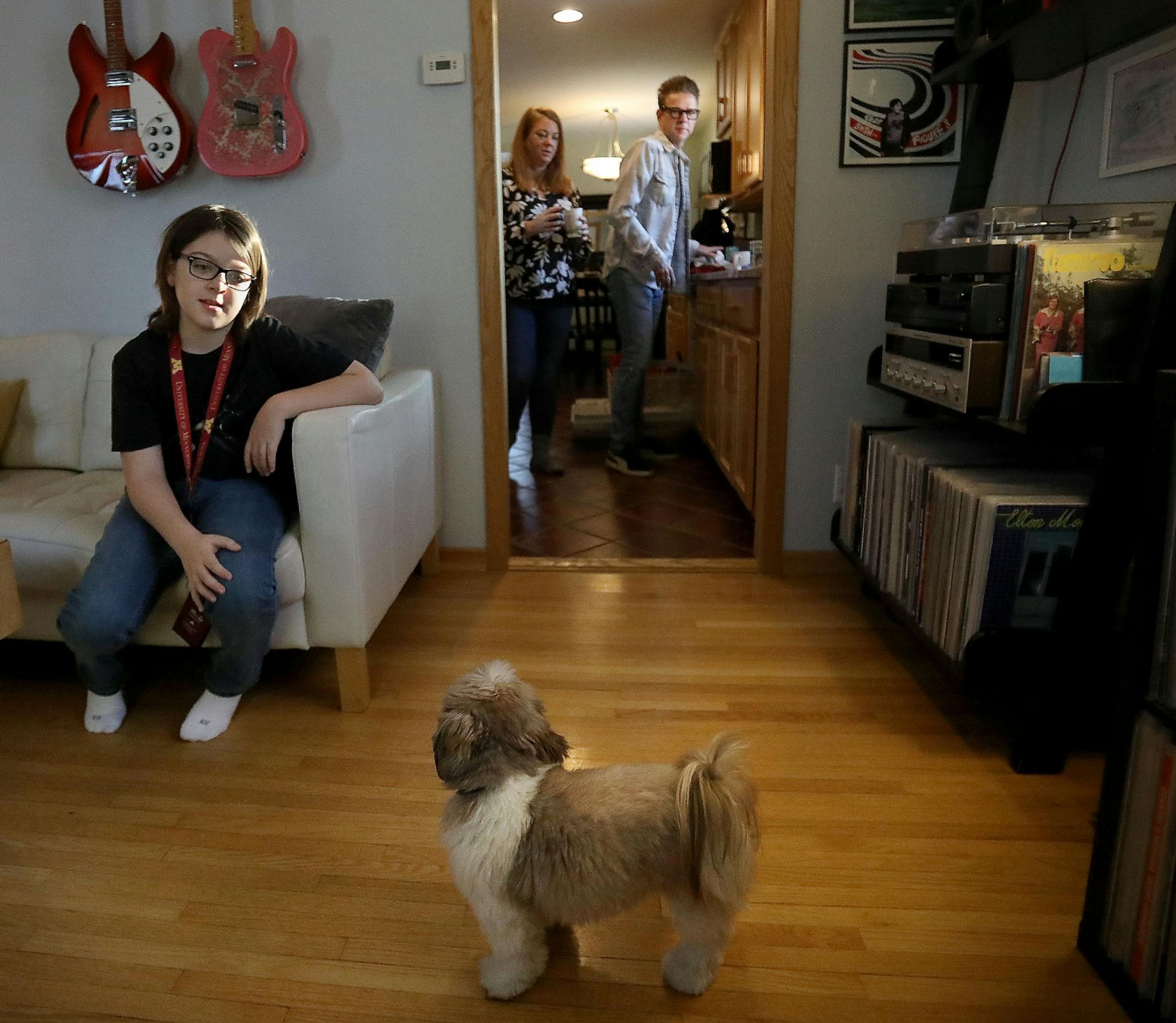 Elliott Tanner, 11, a junior at the University of Minnesota, at home with the family dog, Winston, and his parents Michelle and Patrick, right, in St. Louis Park.