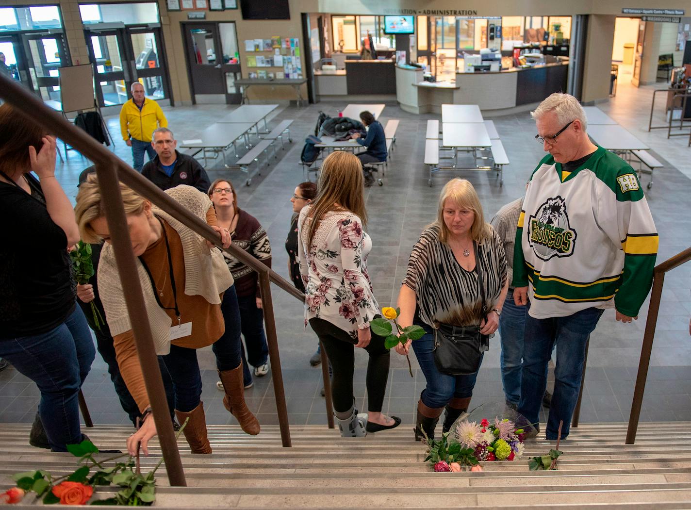 Humboldt mayor Rob Muench, in the Broncos team jersey, along with other mourners lay down flower on the stairs that enter to Elgar Petersen Arena, home of the Humboldt Broncos, in Humboldt, Saskatchewan, Canada on Saturday, April 7, 2018.