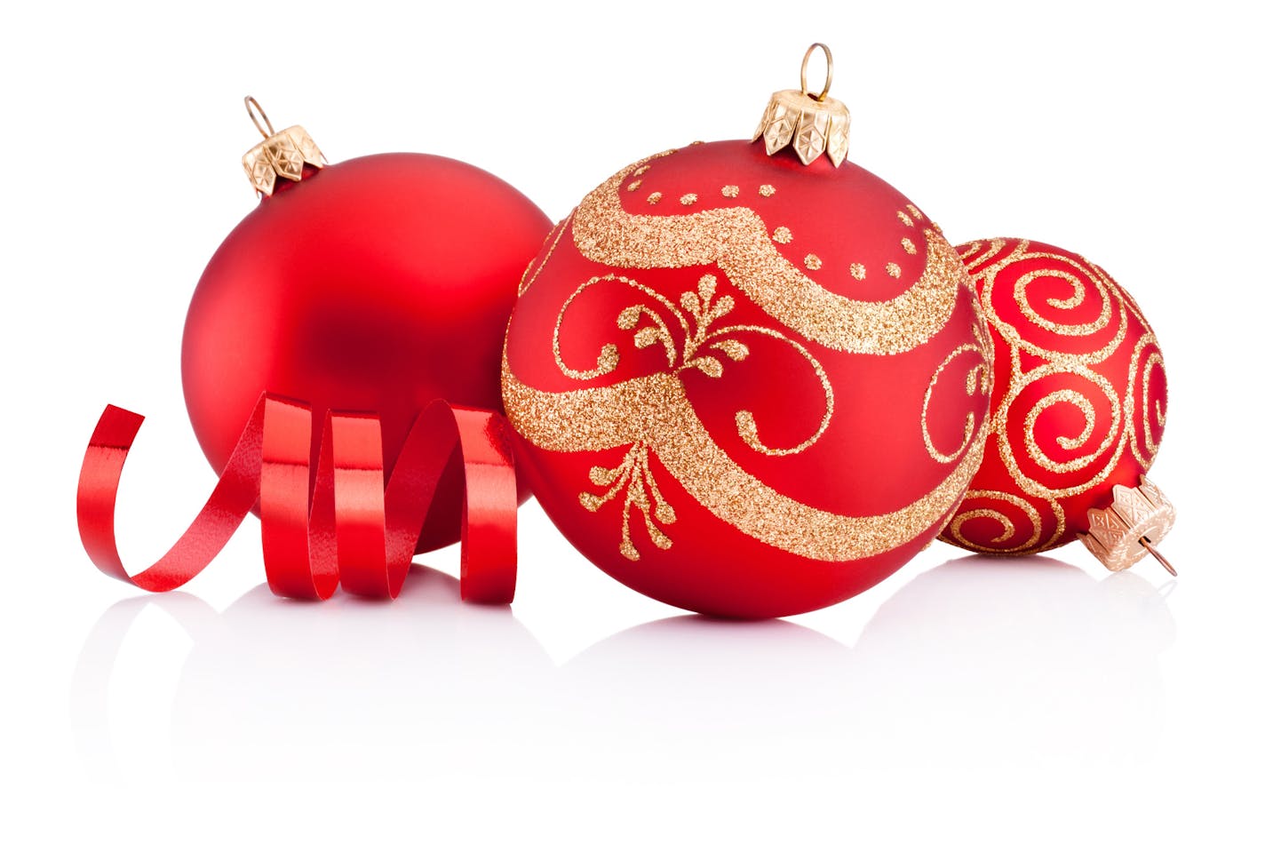 Red Christmas decoration baubles and curling paper isolated on white background istock