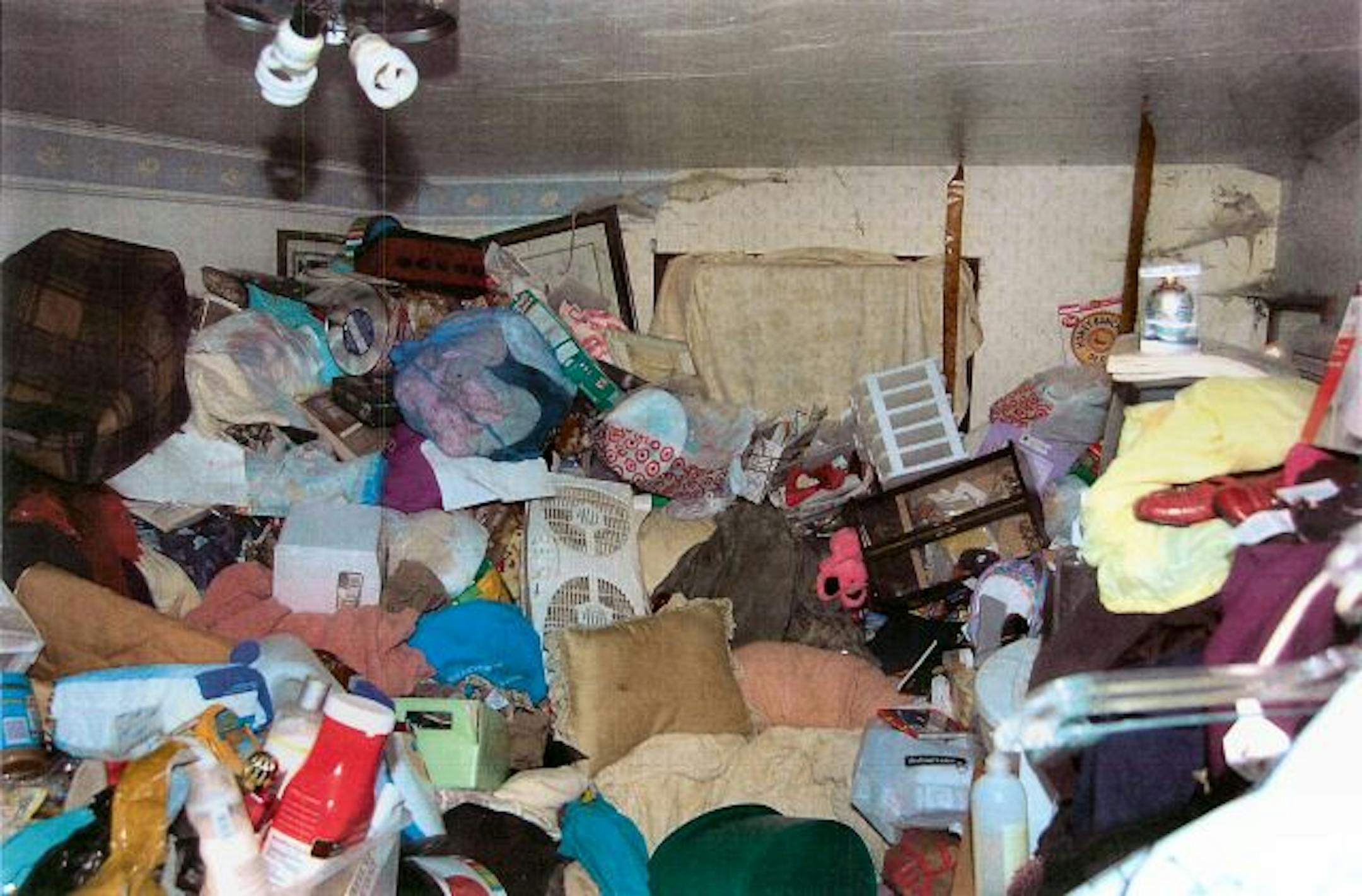 People who hoard compulsively fill their homes with possessions, to the point where they can walk only on paths of compressed garbage and sleep on narrow ledges left on beds and sofas. Water and sewer service often don�t work, leading to sewage problems. Rats and mice reproduce unfettered under piles of stuff. Often the food and clothing are unusable because the smell lingers. This house, fairly trim and neat from the outside, had thick cobwebs, things piled to the ceiling and feces spattered al