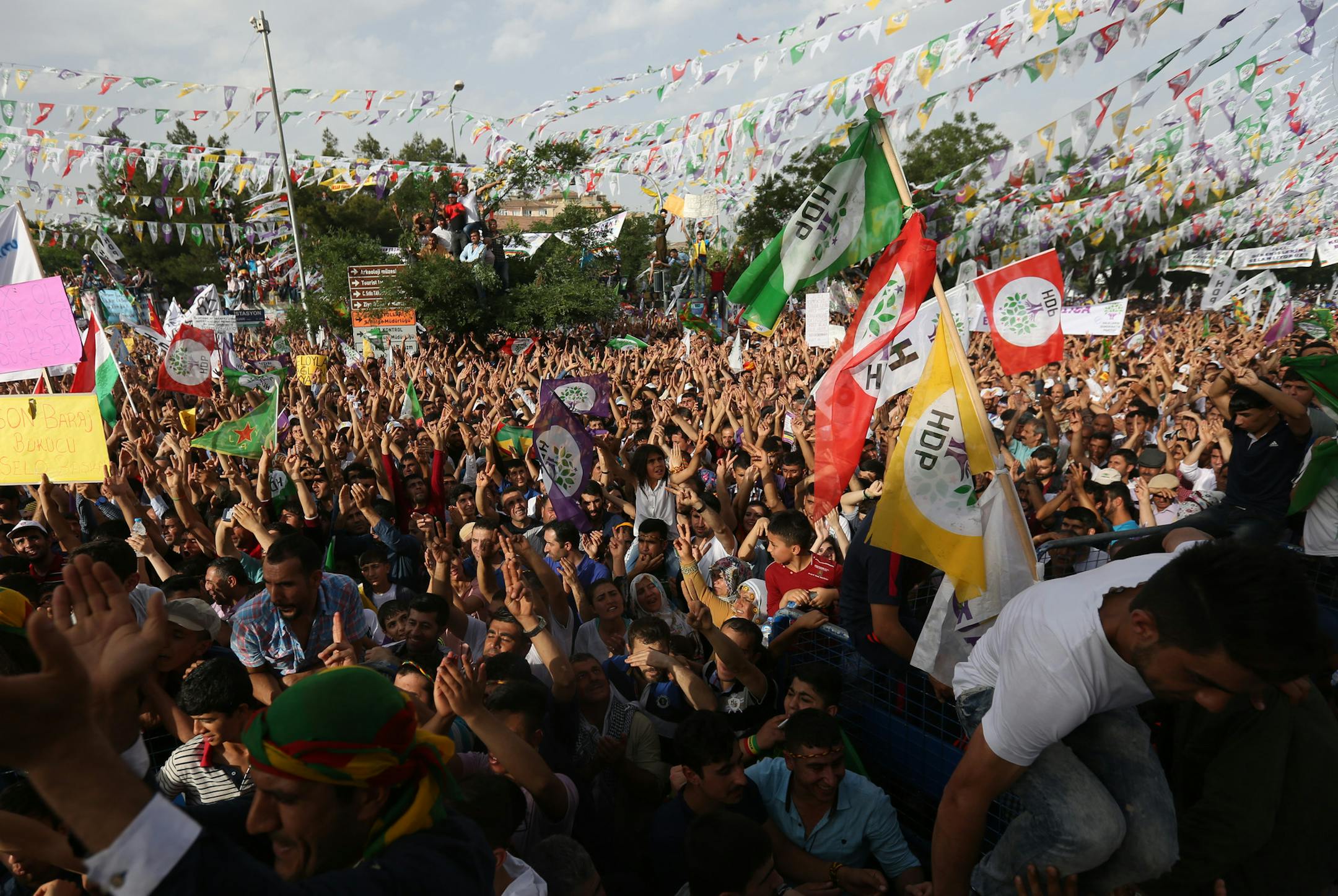 Supporters of Kurdish People’s Democratic Party (DHP) wave flags and chant slogans during a rally in Diyarbakir, southeastern Turkey, Friday, June 5, 2015 ahead of the general election on June 7, 2015. Two blasts occurred five minutes apart at the HDP final election rally as party leader Selahattin Demirtas was preparing to address the crowd in Diyarbakir, the main city in Turkey's predominantly Kurdish southeast. (AP Photo/Emre Tazegul)