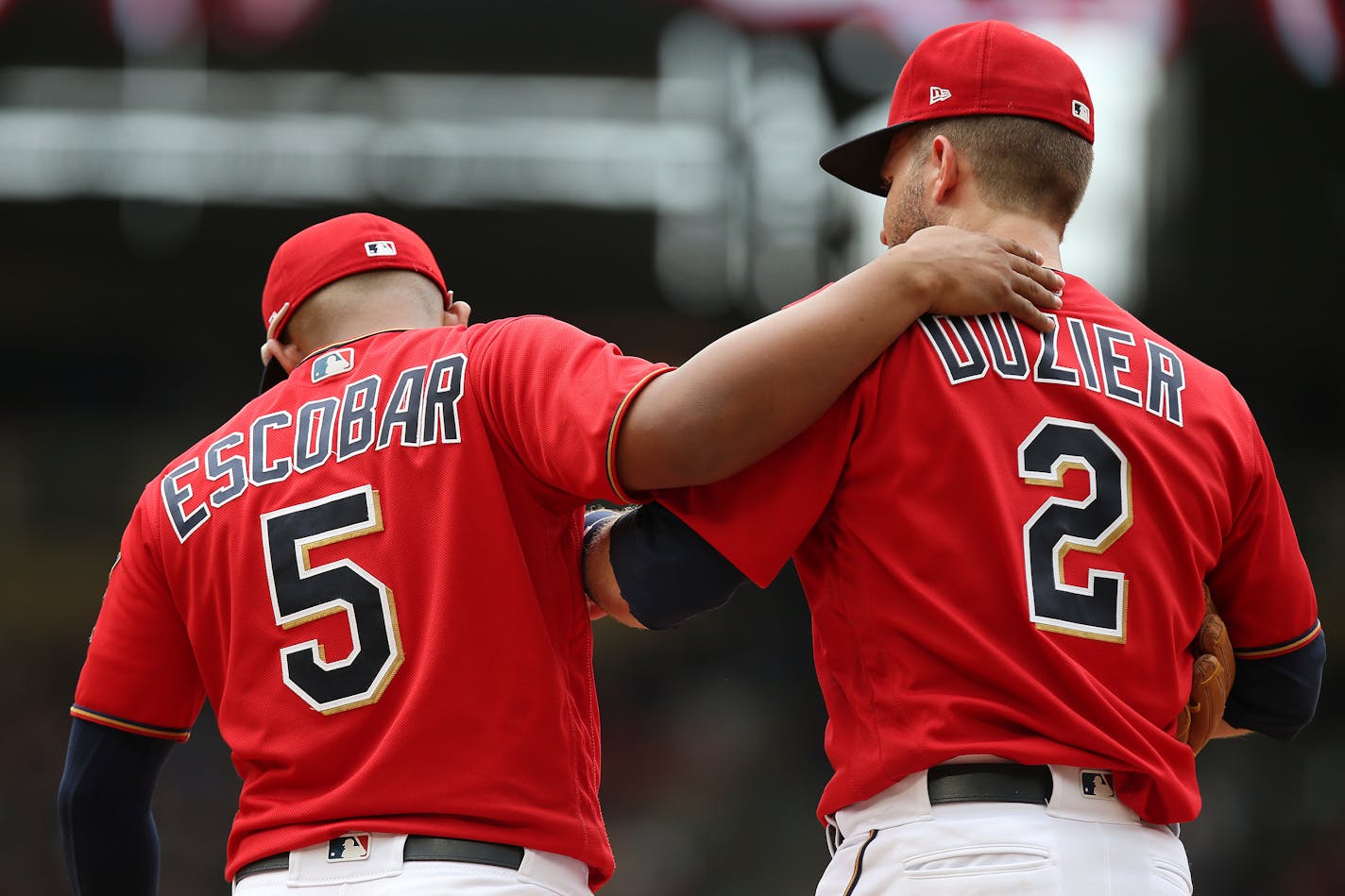 Minnesota Twins Eduardo Escobar and teammate Brian Dozier walk back on to the field at the top of the ninth inning of a baseball game against the Texas Rangers, Sunday, June 24, 2018 in Minneapolis. The Twin won 2-0. (AP Photo/Stacy Bengs)