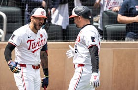 Minnesota Twins outfielder Trevor Larnach (9) right celebrates his 2 run homer with shortstop Carlos Correa (4) in the firth inning at Target Field in