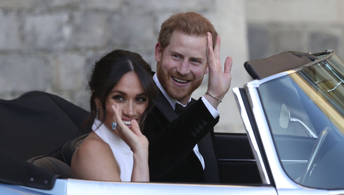 The newly married Duke and Duchess of Sussex, Meghan Markle and Prince Harry, leave Windsor Castle in a convertible car after their wedding in Windsor, England, to attend an evening reception at Frogmore House, hosted by the Prince of Wales, Saturday, May 19, 2018. (Steve Parsons/pool photo via AP)