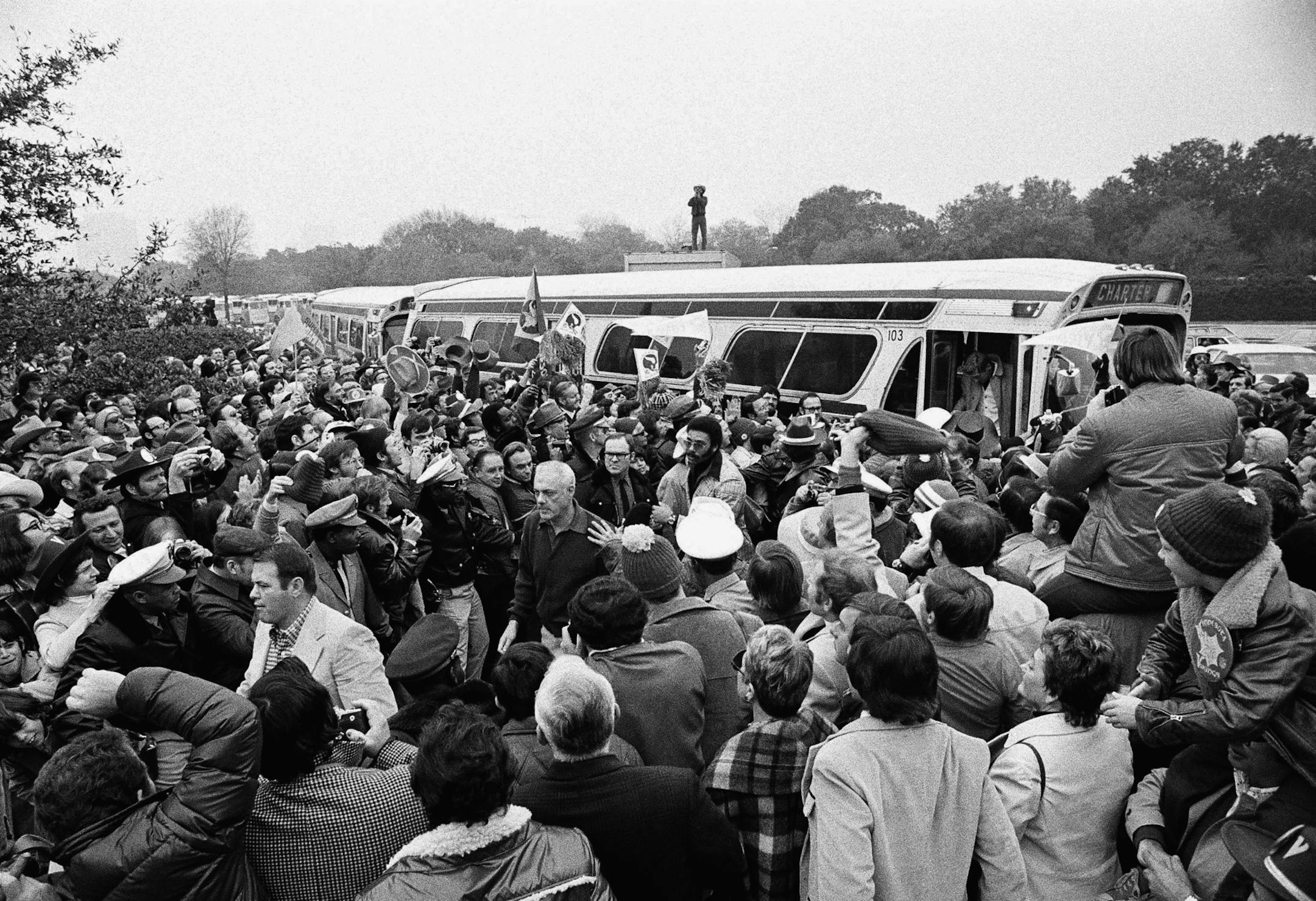 Minnesota head coach Bud Grant, white-haired, center, is among his Viking players as they leave the bus following tehir arrival at Rice Stadium in Houston, Sunday, Jan. 13, 1974 for the Super Bowl game against the Miami Dolphins. (AP Photo/Ed Kolenovsky) ORG XMIT: APHS174165