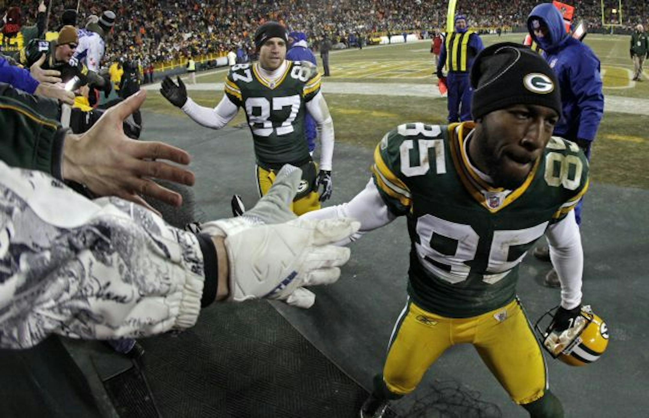 The Lambeau Slap: Packers receivers Greg Jennings (85) and Jordy Nelson (87) got a few high-fives from fans at Lambeau field after Green Bay defeated Chicago 10-3 and secured a playoff spot.