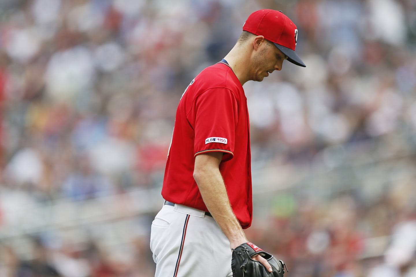 Minnesota Twins pitcher Taylor Rogers heads to the dugout after he was pulled in the 10th inning of a baseball game shortly after giving up a grand slam to Cleveland Indians' Carlos Santana, Sunday, Aug. 11, 2019, in Minneapolis. (AP Photo/Jim Mone)