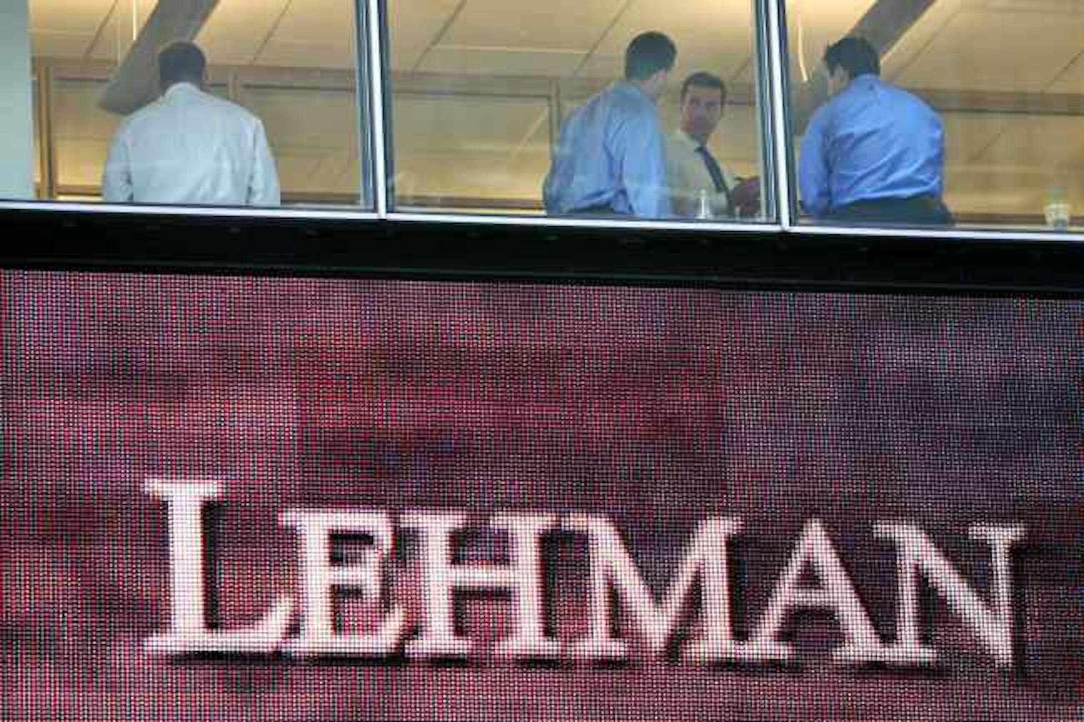 In this Sept. 16, 2008 file photo, people work inside the Lehman Brothers headquarters in New York. Shoppers won't be picking up little tables from the Bombay Company in the coming year. Or investing with Lehman Brothers and Bear Stearns. Or flying to Hawaii on Aloha Airlines. Or buying ultra-cheap tickets on Skybus either. All those names gave up the ghost this year, victims of the economy, the financial meltdown or other factors. **FILE** In this Sept. 16, 2008 file photo, people work inside t