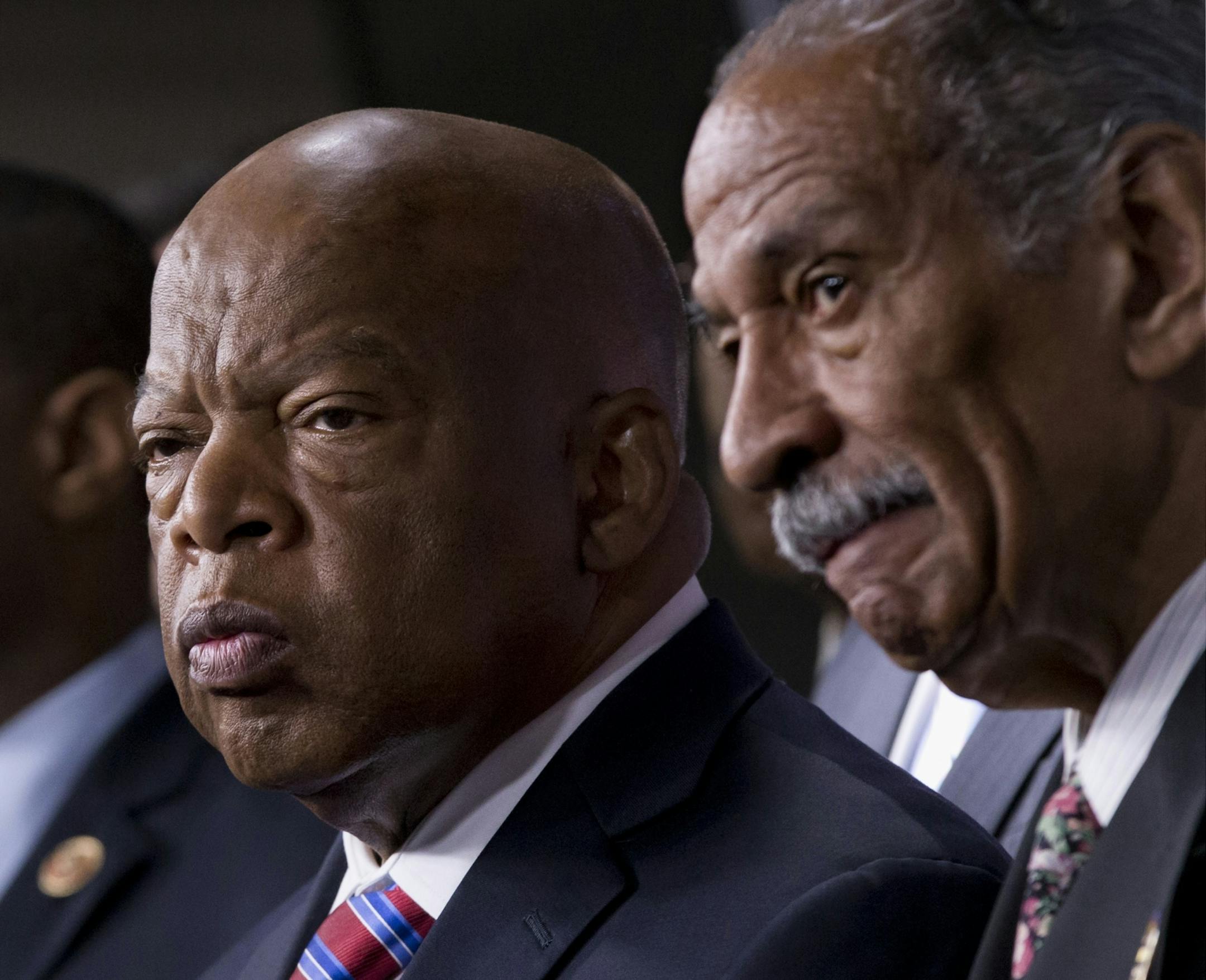 Rep. John Lewis, D-Ga., left, and Rep. John Conyers, D-Mich., right, co-chairs of the Civil Rights Taskforce of the Congressional Black Caucus, join other members of the House to express disappointment in the Supreme Court's decision on Shelby County v. Holder that invalidates Section 4 of the Voting Rights Act.