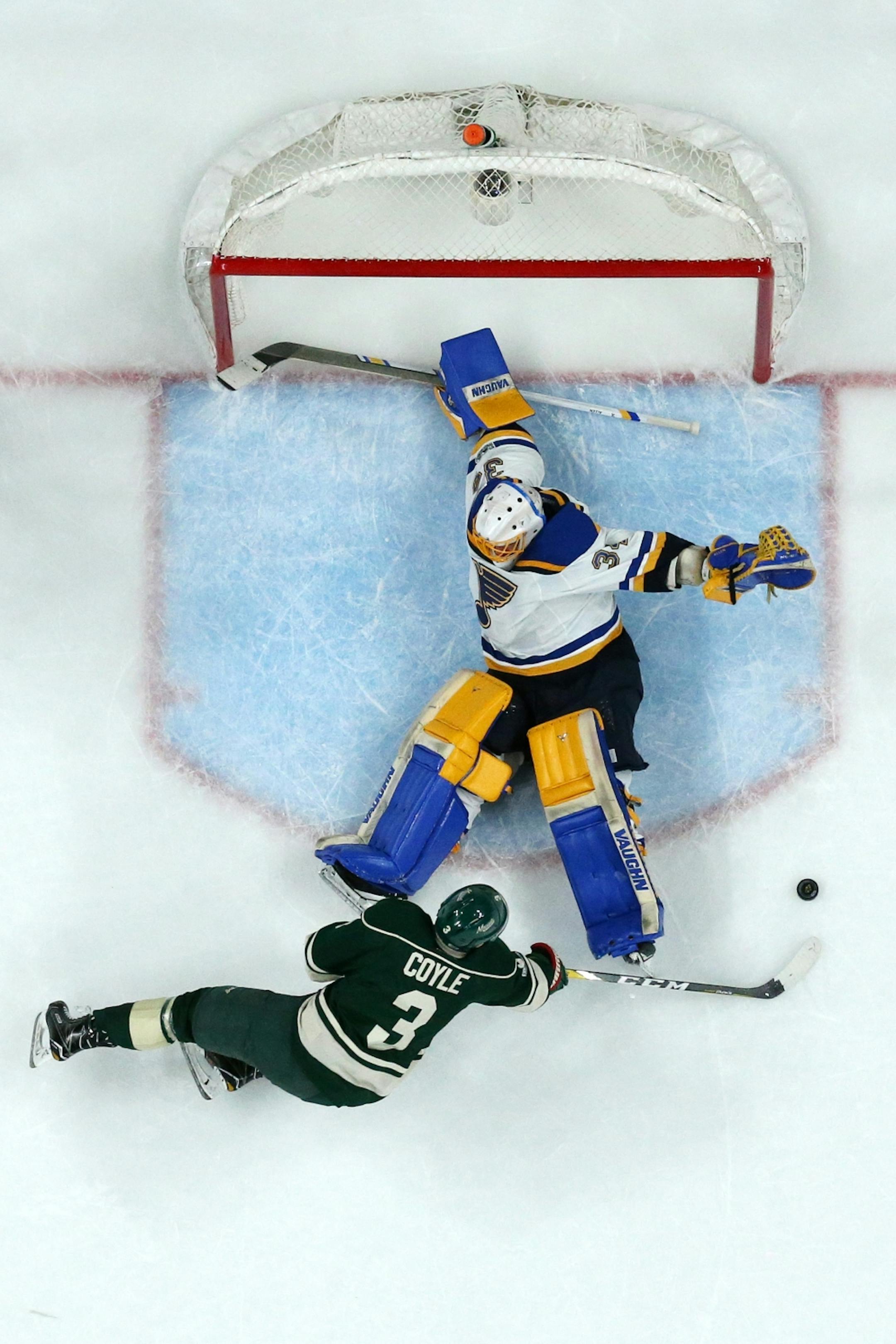 Minnesota Wild center Charlie Coyle (3) got tripped up as he tried to score on St. Louis Blues goalie Jake Allen (34) in the second period.
