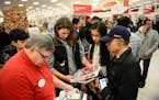 Doug Raney, an electronics team member with Target, helped the Quach family, of Prior Lake, locate items on their holiday shopping wish list Thursday 