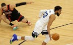 Minnesota Timberwolves center Karl-Anthony Towns (32) leaves Chicago Bulls center Nikola Vucevic (9) on the floor in the first quarter during an NBA b