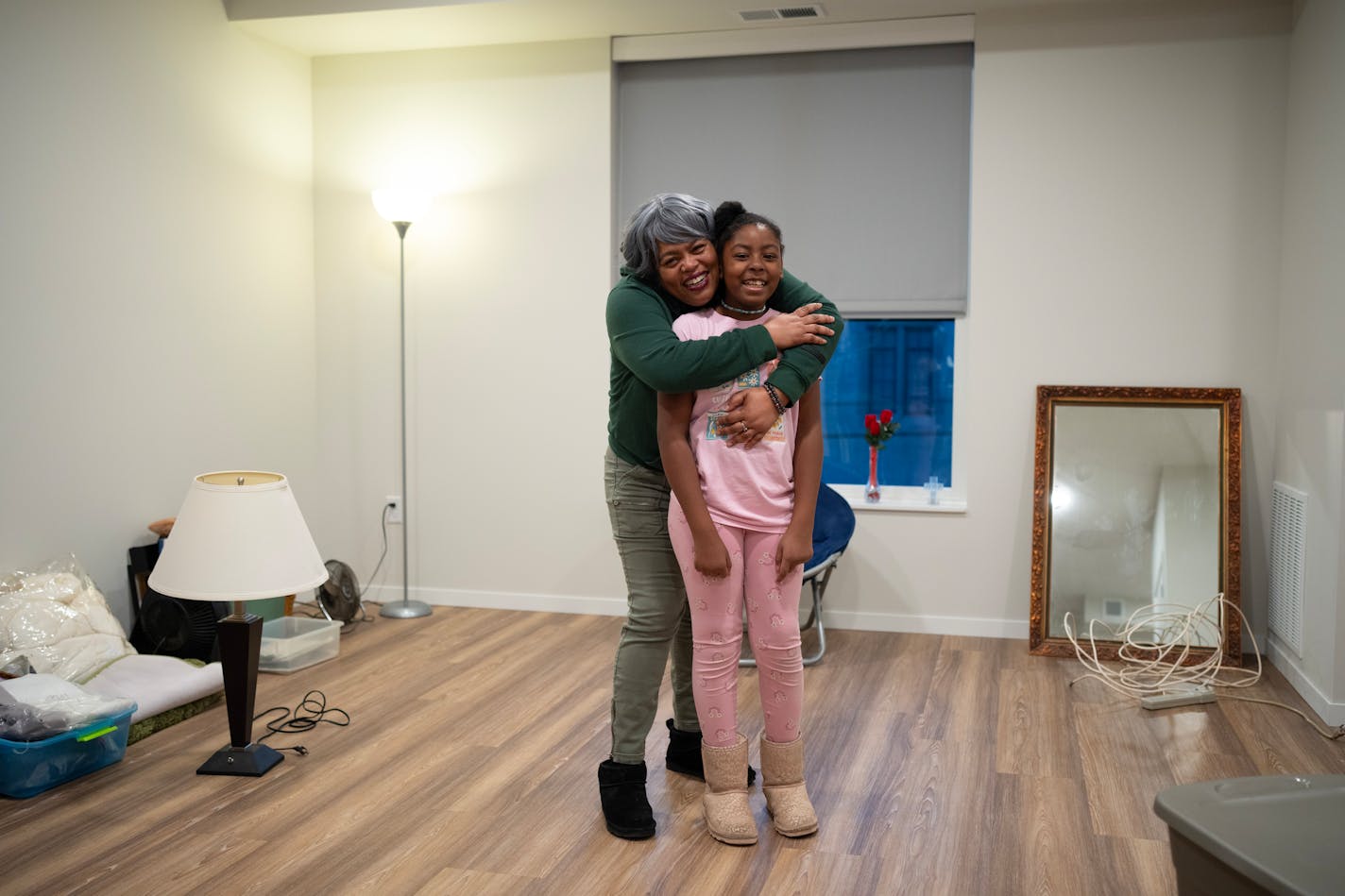 Talicha Whitmore and her daughter, Brooklyn, 10, in their new apartment Monday evening, January 22, 2024. Whitmore is in the process of moving into the Belfry Apartments, an affordable housing initiative of Calvary Lutheran Church, just a block from George Floyd Square in Minneapolis.   ]   JEFF WHEELER • Jeff.Wheeler@startribune.com