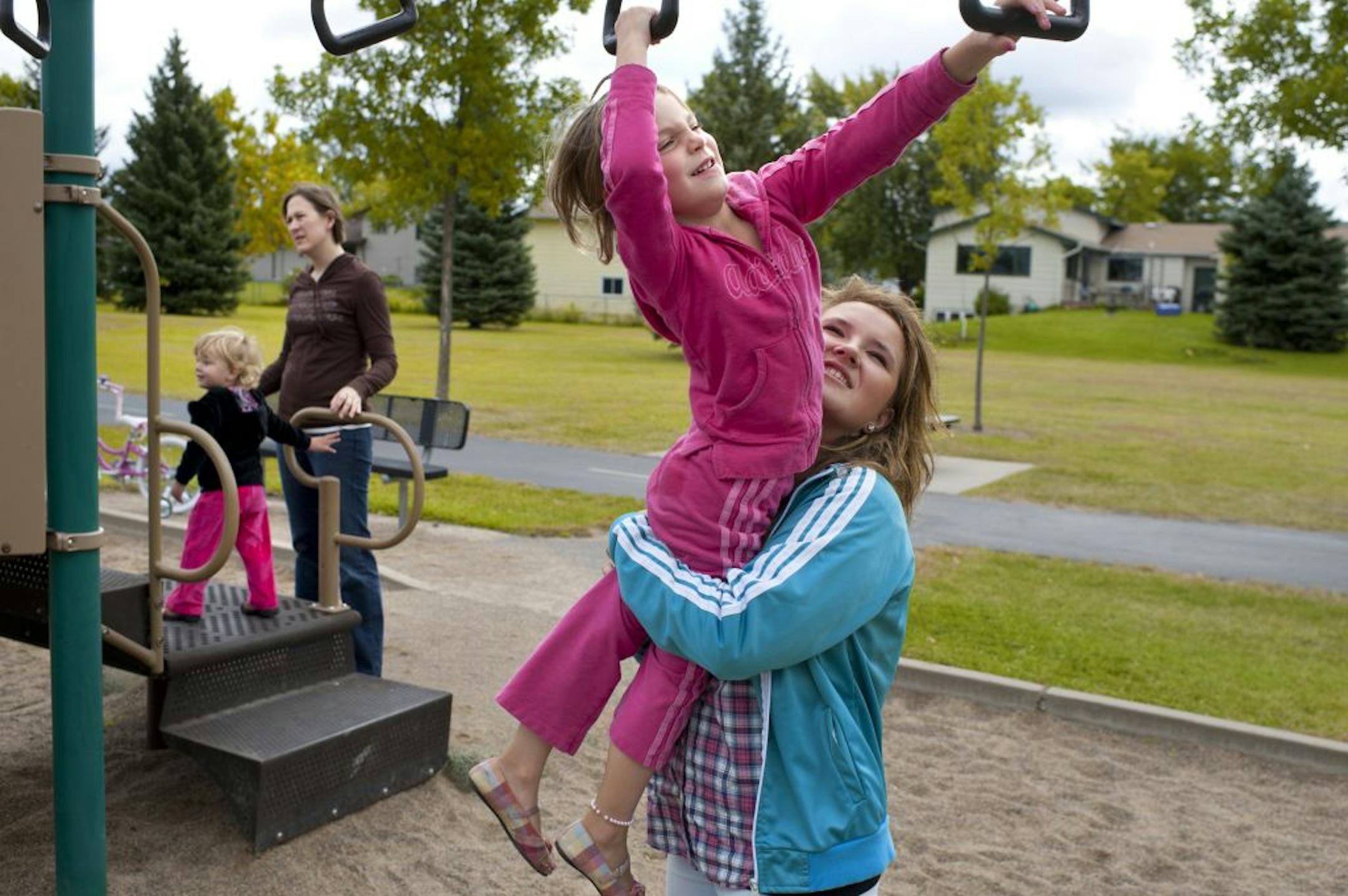 Veterinarian Amy Haarstad, at left, who has three young children, has employed au pairs for a couple of years, including Chrissy Bieche, foreground.
