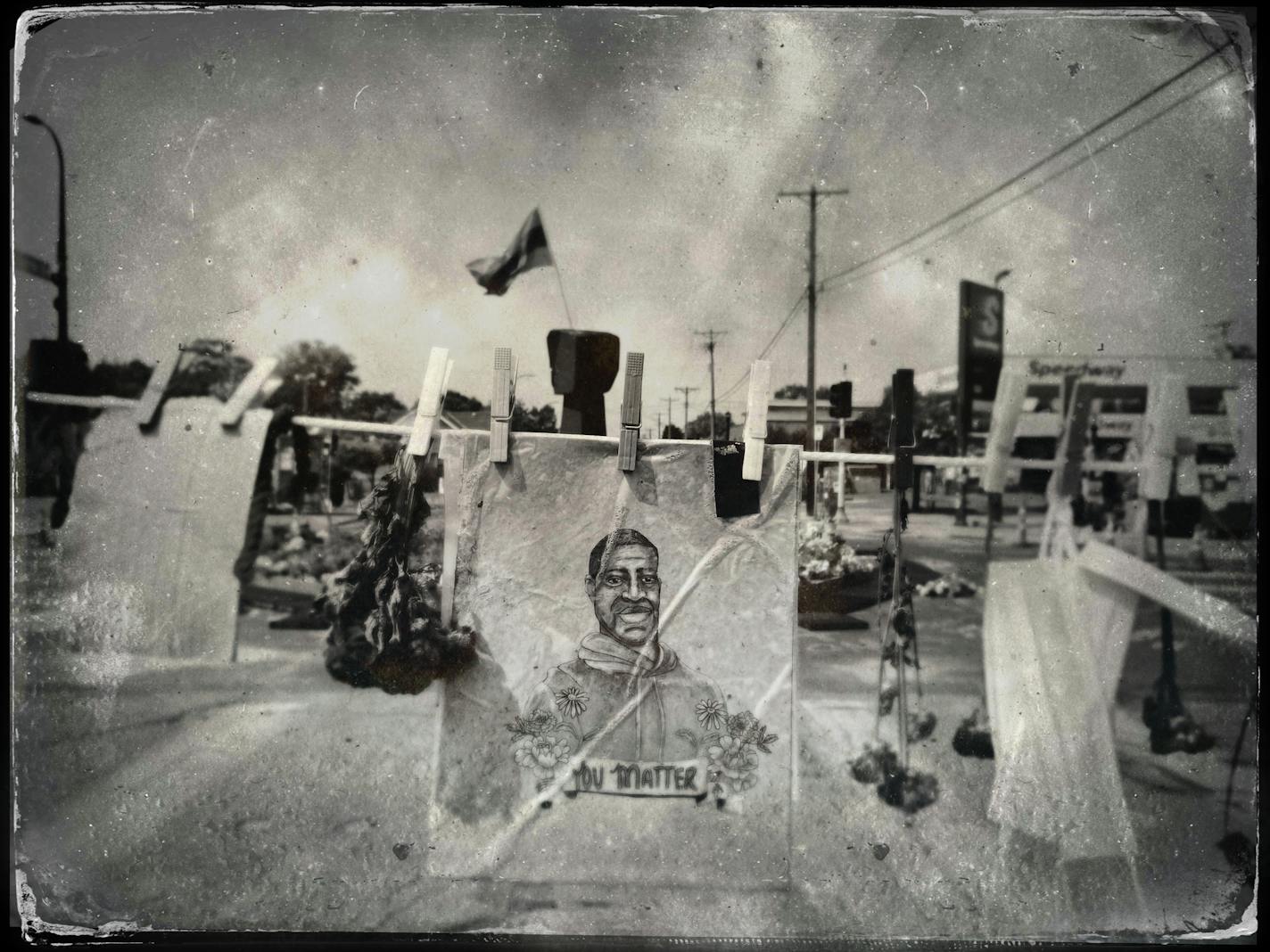 A drawing of George Floyd hung at the site of his death at the intersection of E. 38th Street and S. Chicago Avenue.