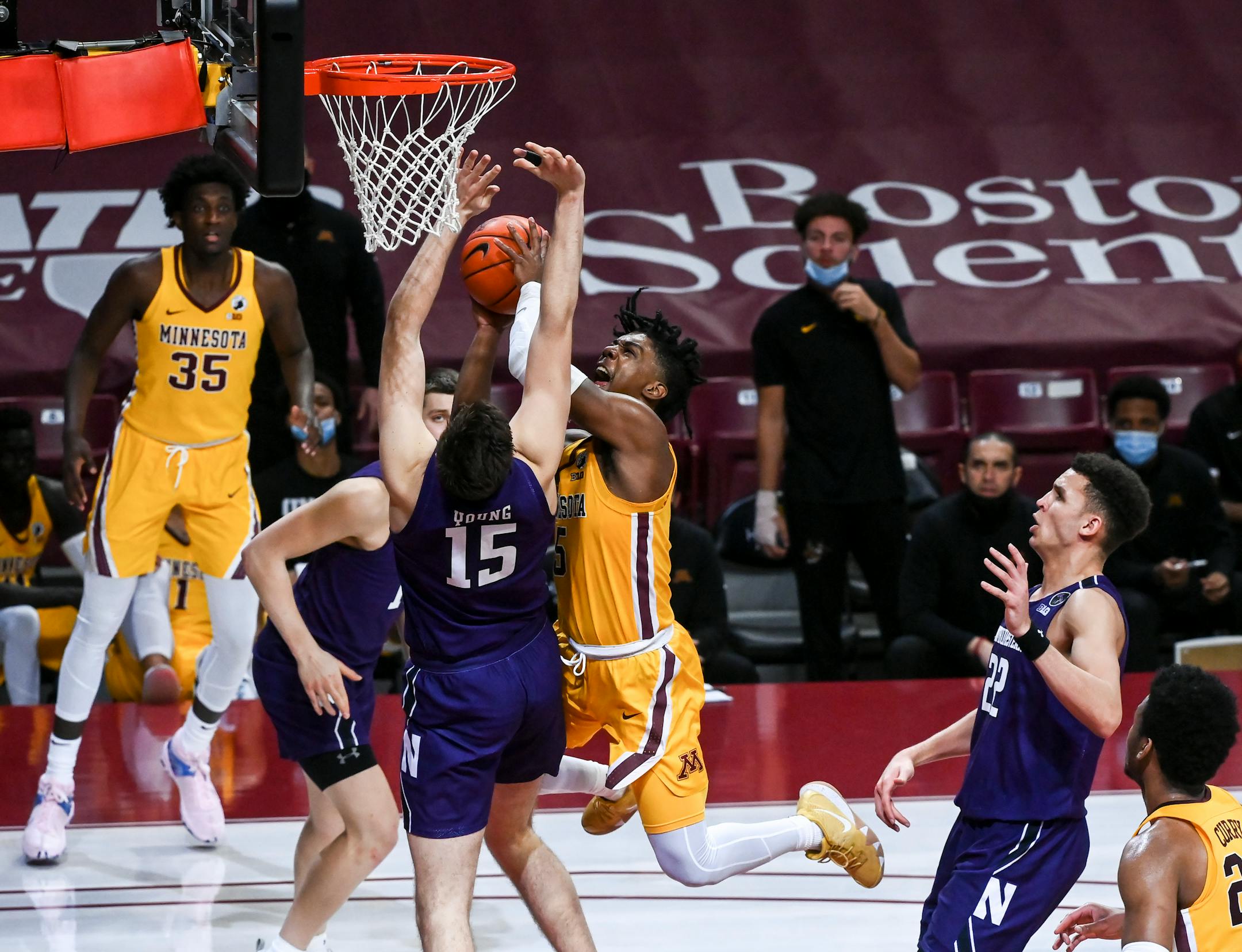 Minnesota Gophers guard Marcus Carr (5) scored a layup and was fouled by Northwestern Wildcats center Ryan Young (15) in the second half for an and-one opportunity.