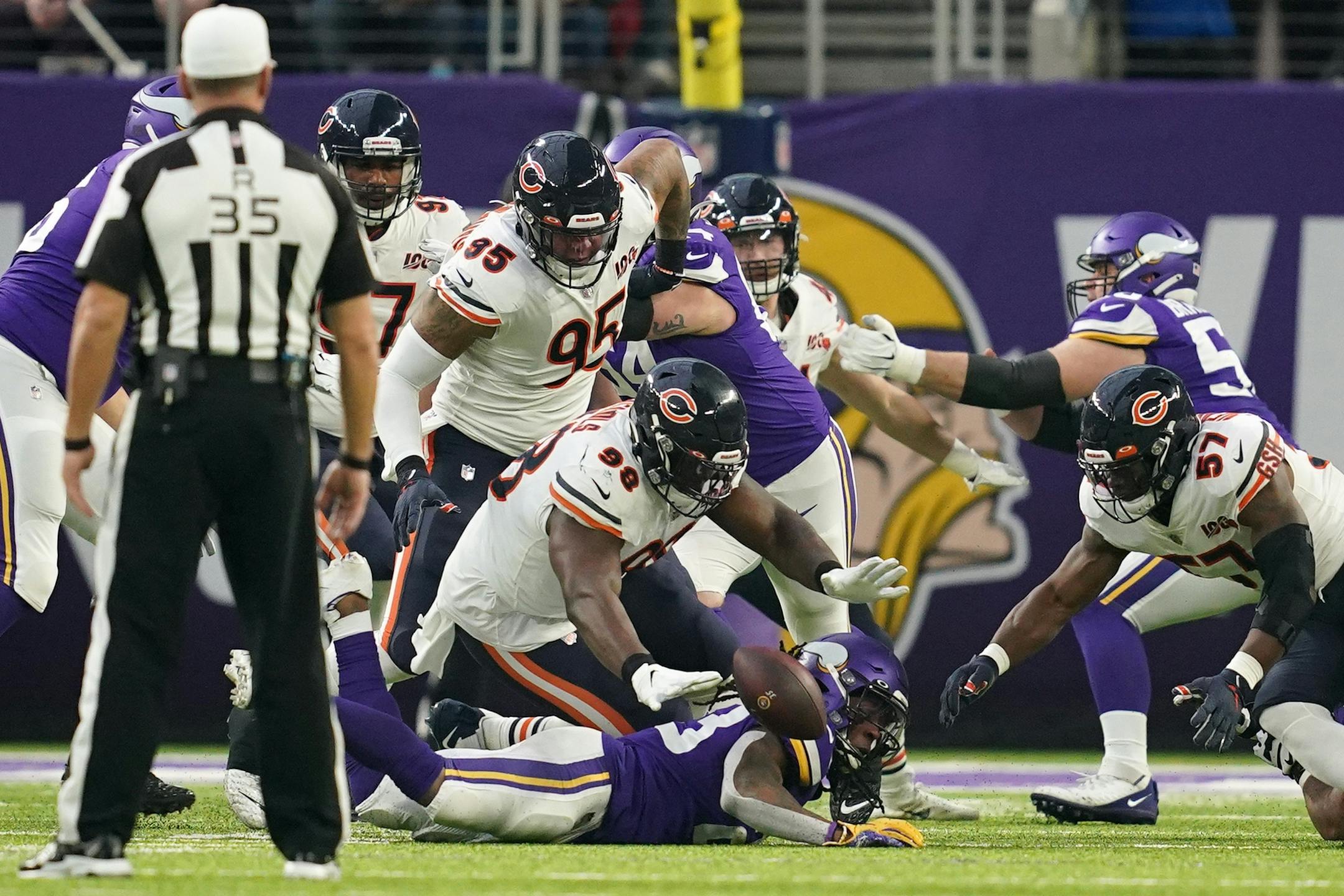 Chicago Bears defensive tackle Bilal Nichols (98) dove on a fumble by Minnesota Vikings running back Mike Boone (23) for a turnover in the first quarter.