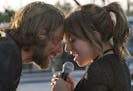 This image released by Warner Bros. shows Bradley Cooper, left, and Lady Gaga in a scene from the latest reboot of the film, "A Star is Born." (Neal P