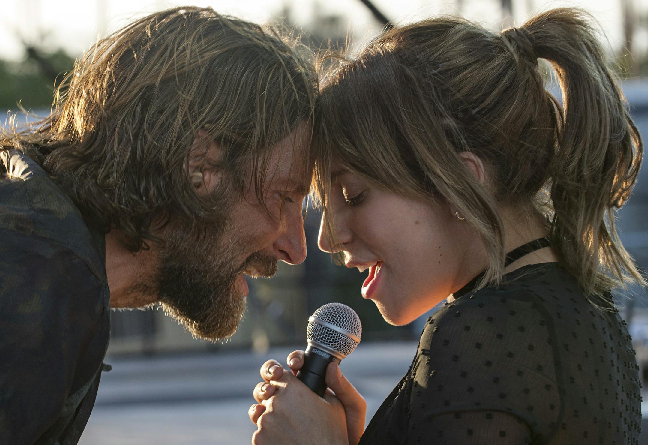 This image released by Warner Bros. shows Bradley Cooper, left, and Lady Gaga in a scene from the latest reboot of the film, "A Star is Born." (Neal Preston/Warner Bros. via AP)