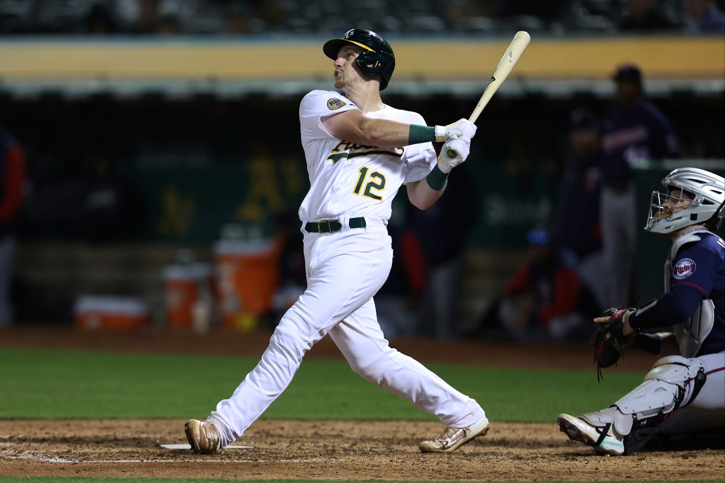 Oakland's Sean Murphy watches his two-run single in front of Twins catcher Ryan Jeffers during the seventh inning