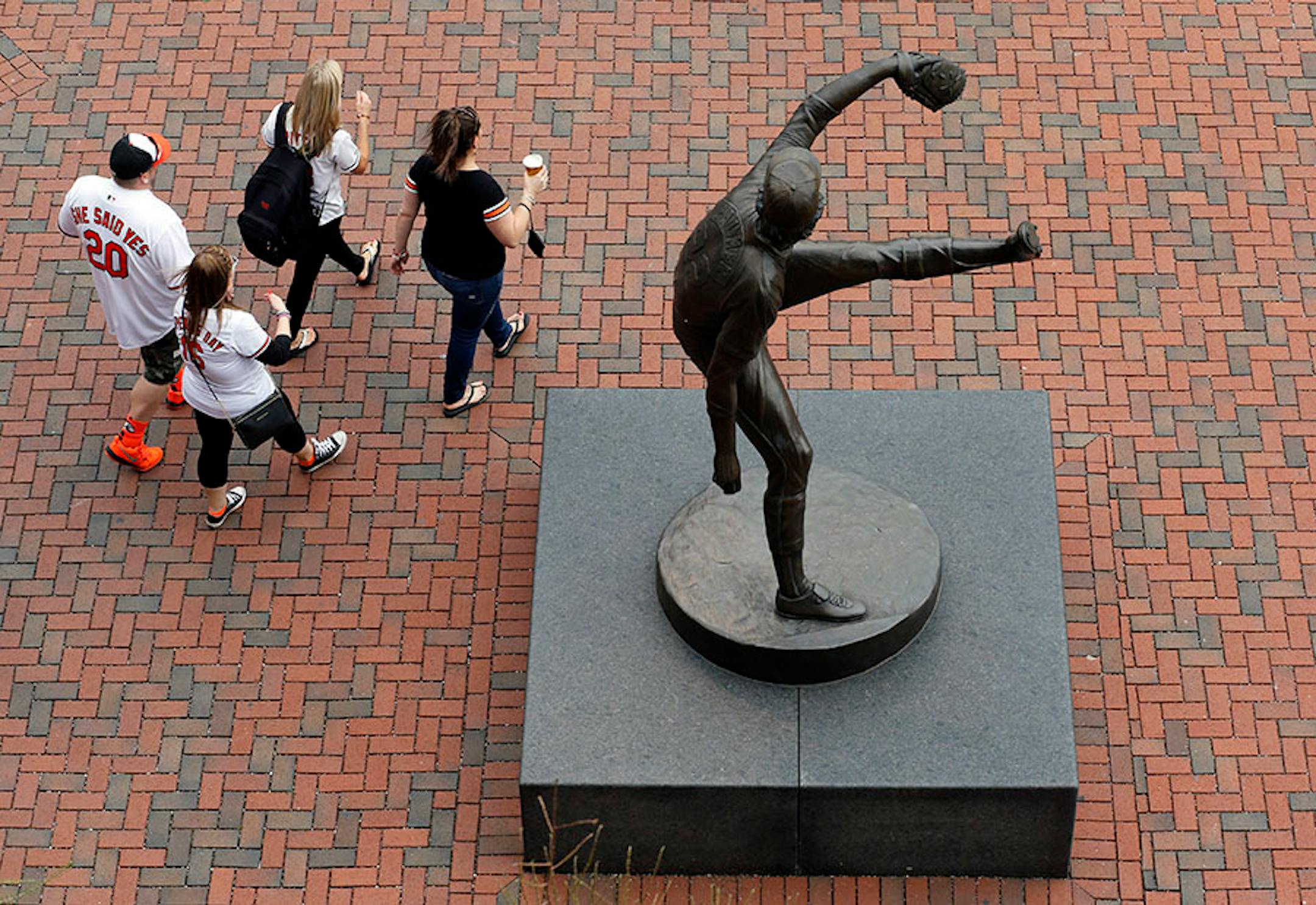 Fans walk past a statue of former Baltimore Orioles pitcher Jim Palmer before an opening day baseball game between the Orioles and the Minnesota Twins in Baltimore, Monday, April 4, 2016. (AP Photo/Patrick Semansky)