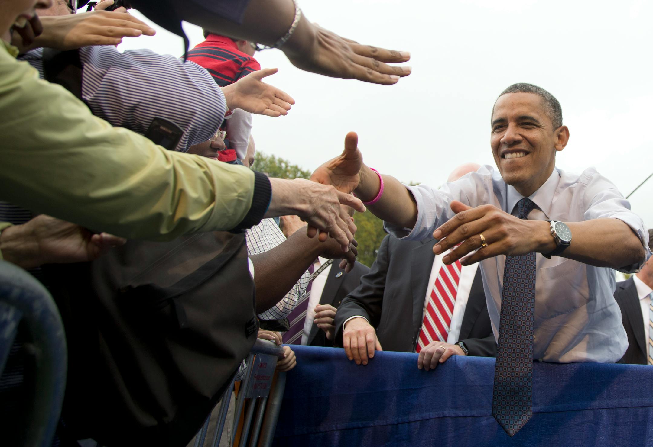 President Barack Obama stretches to shakes hands after speaking about the choice facing women in the upcoming election, Friday, Oct. 19, 2012, at a campaign event at George Mason University in Fairfax, Va.