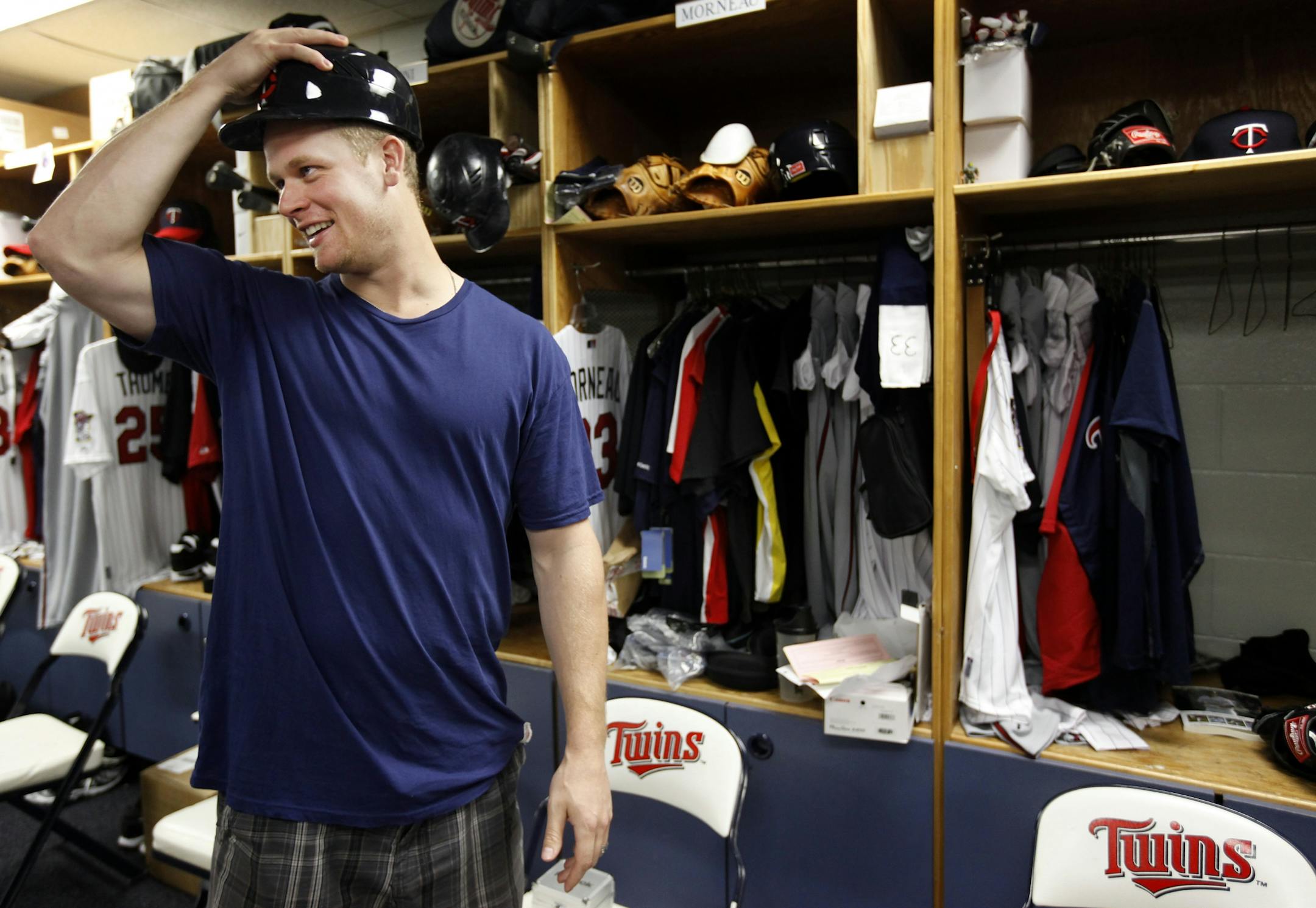 Twins first baseman Justin Morneau, who reported for spring training Monday, tried on a helmet in the clubhouse at Hammond Stadium. Morneau might wear a helmet while in the field during batting practice until he is cleared for all activities to make sure he isn't hit by an off-target throw or batted ball.