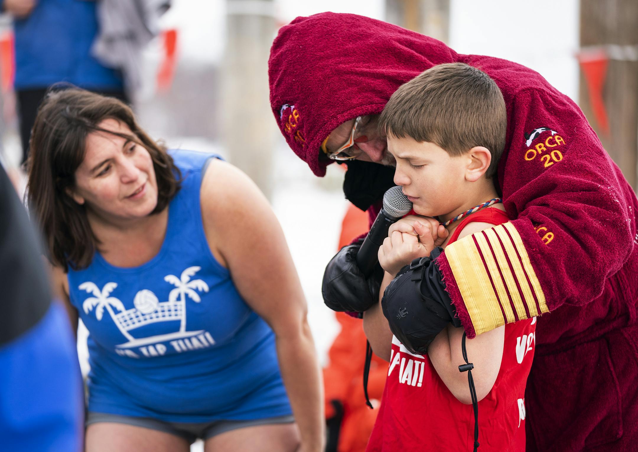 Logan Grote, 10, of Maple Grove got a pep talk before jumping from co-founder Bill Wenmar as Grote's mother Robin stood by during the ALARC Ice Dive. ] LEILA NAVIDI • leila.navidi@startribune.com BACKGROUND INFORMATION: Divers participate in the 30th Anniversary ALARC Ice Dive on New Year's Day into Lake Minnetonka in Excelsior on Wednesday, January 1, 2020.