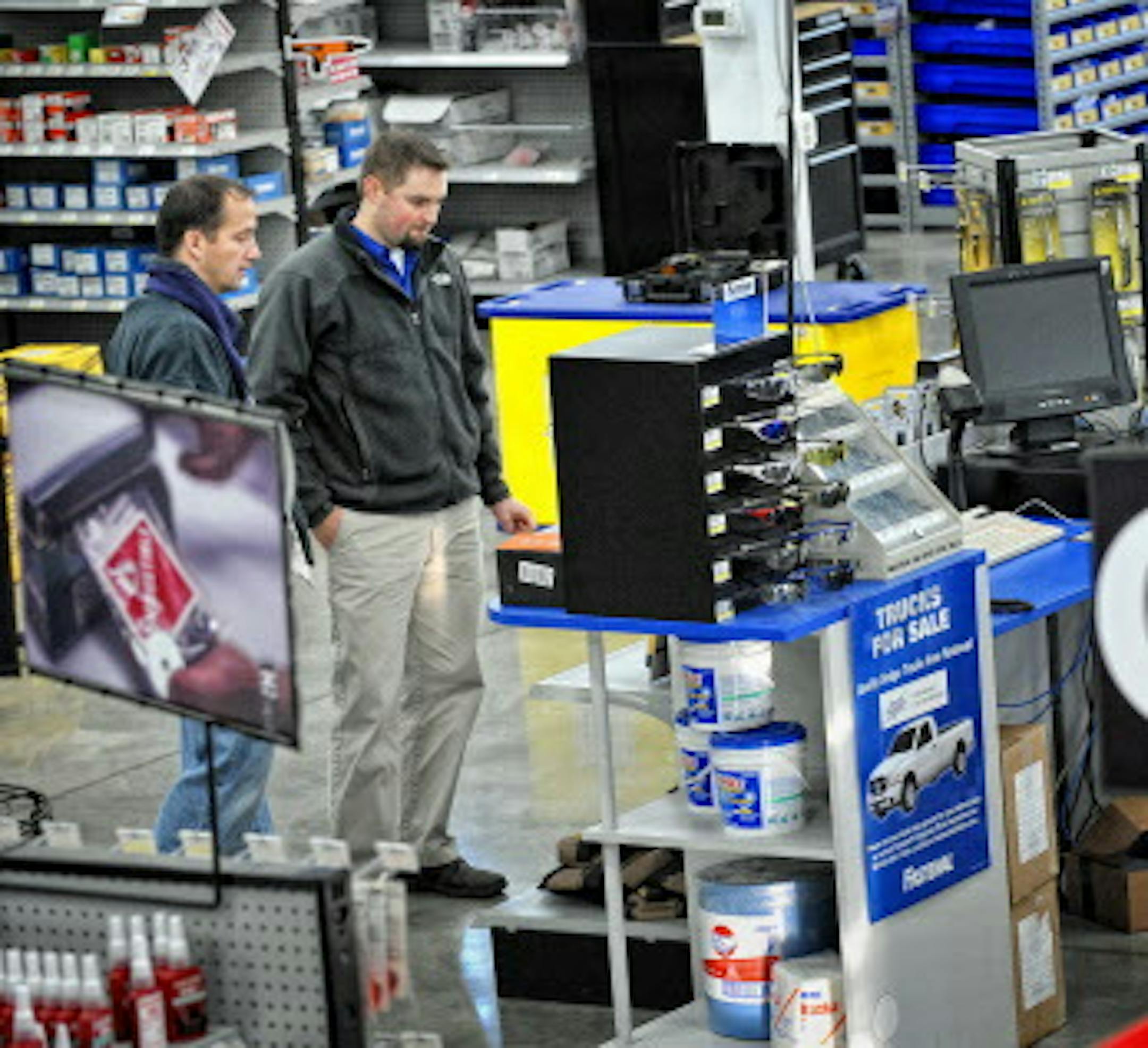 GLEN STUBBE • gstubbe@startribune.com -- Tuesday, November 10, 2009 -- Burnsville, Minn. -- ] Burnsville Fastenal general manager Graham Sievers, right helped customer Joel Posner with a hardware selection.