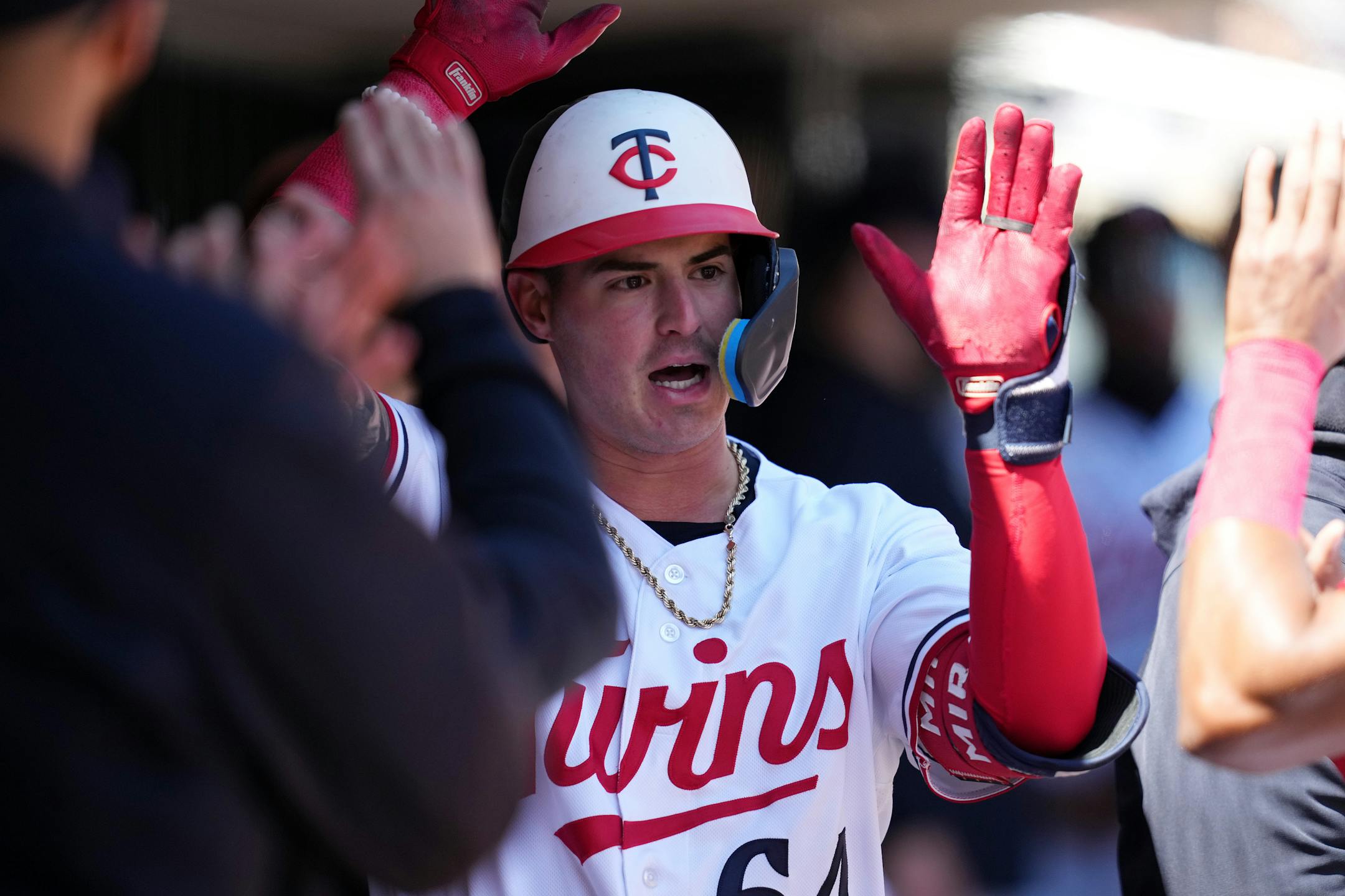 Minnesota Twins third baseman Jose Miranda (64) celebrates in the dugout after hitting a solo home run in the second inning.
