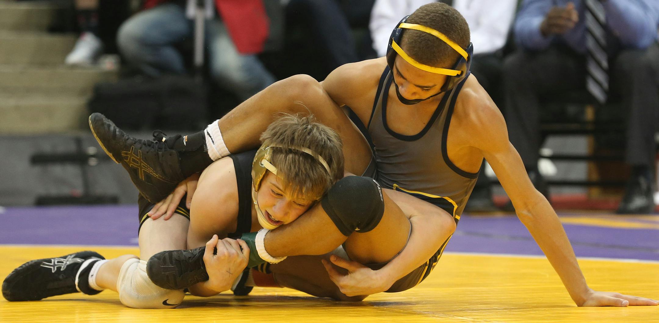 Apple Valley's Kyle Rathman tried to get Prior Lakes Zack Smith on his back during the 106 weight class. ] (KYNDELL HARKNESS/STAR TRIBUNE) kyndell.harkness@startribune.com - 1A team State wrestling tournament at the Xcel Energy Center in St. Paul Thursday, February 27, 2014.