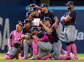 Twins players pose for a photo after Sunday's victory in Toronto, with Max Kepler holding up a sign for his mother on Mother's Day.