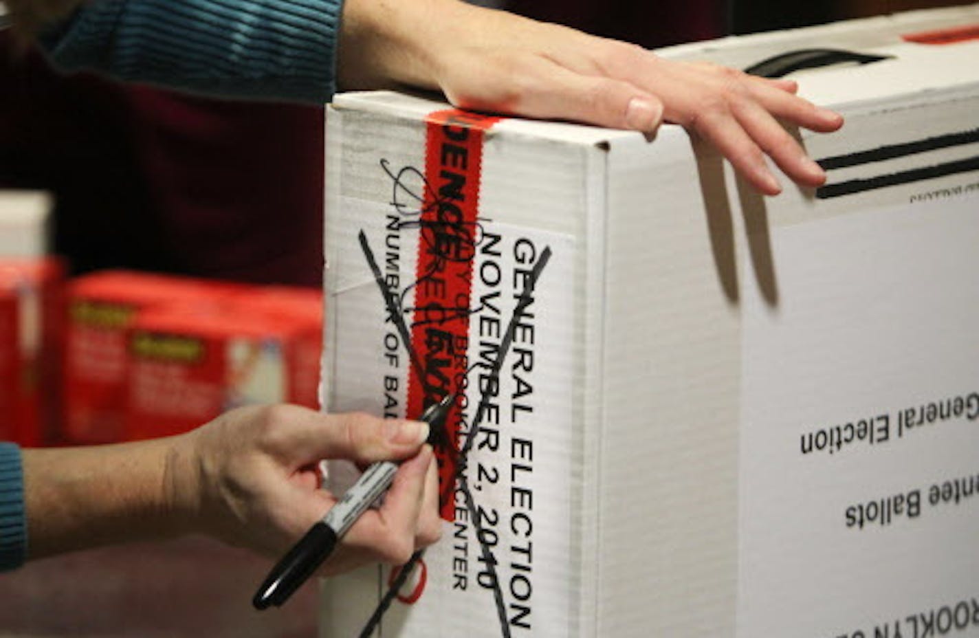 DAVID JOLES &#x2022; djoles@startribune.com - Nov. 4, 2010 - Minneapolis, MN - ] Hennepin County election officials and law enforcement officers escort ballots being brought into the Government Center from Mound and Shorewood. The ballots were taken to a secure site, logged in and under 24 hour sheriff's department security, before the manual recount begins on Nov. 29. In this photo:] A box of ballots from Brooklyn Center is logged in and secured.