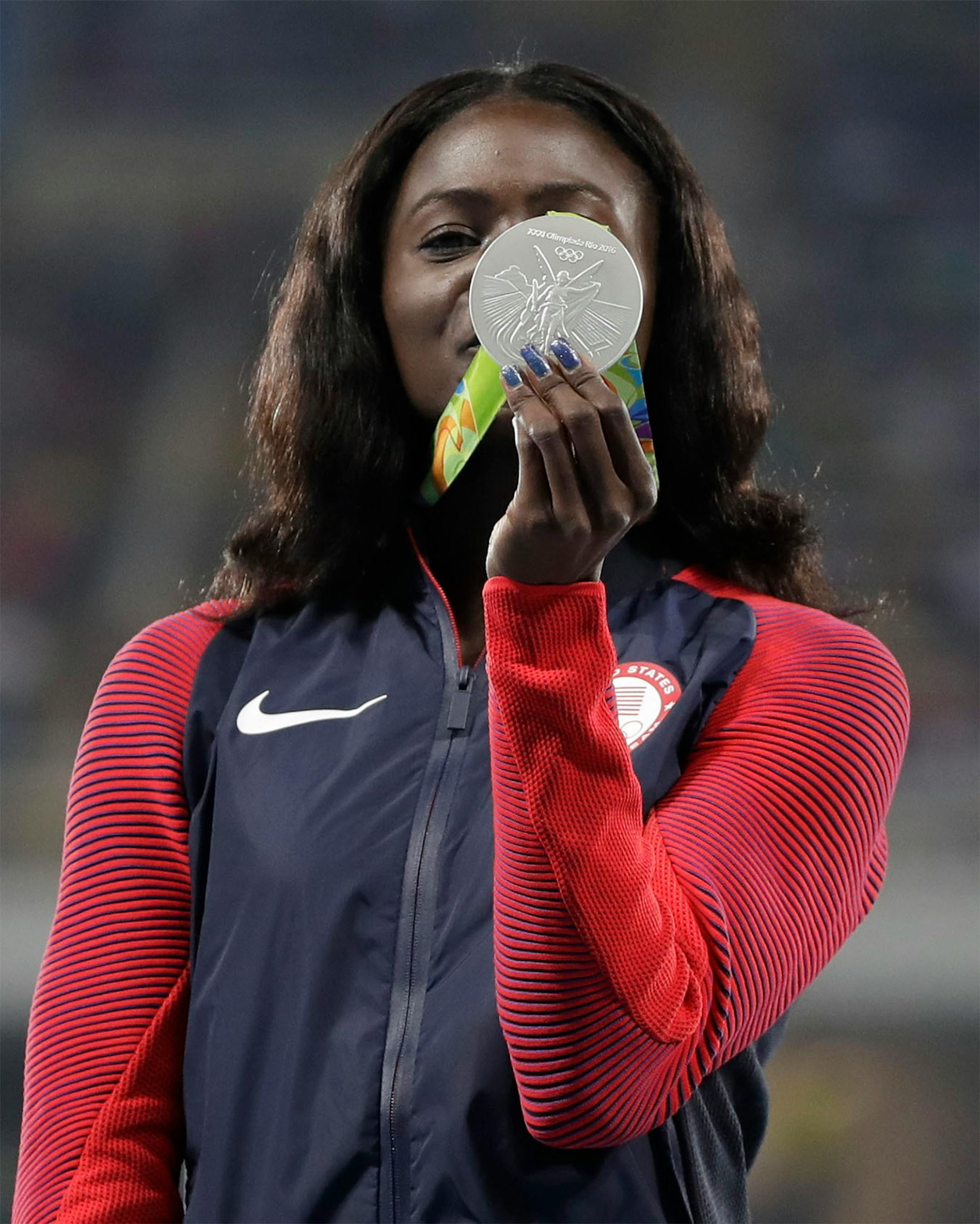 United States' Tori Bowie displays her silver medal for the women's 100-meter final during the athletics competitions of the 2016 Summer Olympics at the Olympic stadium in Rio de Janeiro, Brazil, Sunday, Aug. 14, 2016.