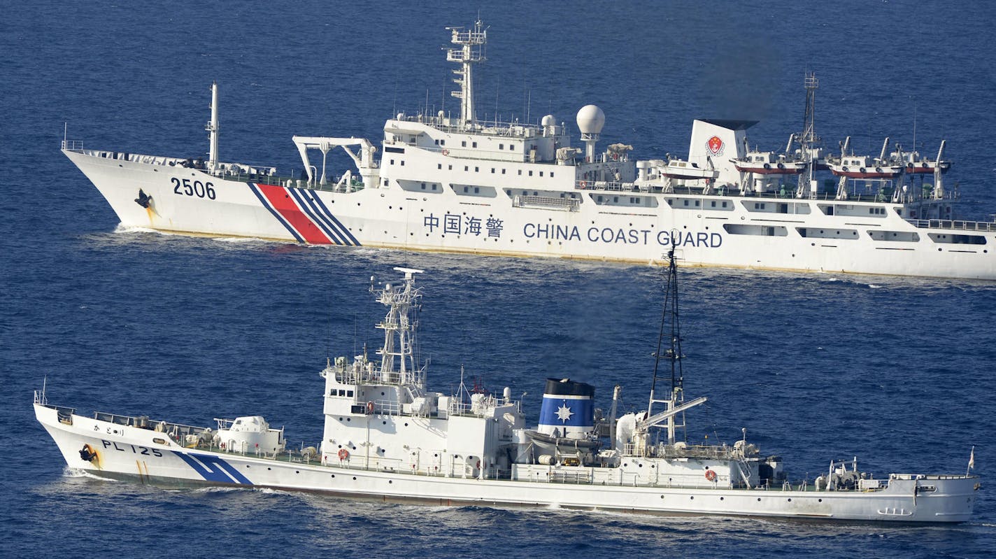 In this Wednesday, Sept. 11, 2013 photo, a China coast guard vessel numbered 2506, top, sails along the Japan coast guard ship Katori in the continuous zone of Japan's territorial waters off the disputed East China Sea islands called Senkaku in Japanese and Diaoyutai in Chinese. A big problem for China is its bad blood with virtually all of its neighbors, many of whom are key players in the search of missing Malaysia Airlines Boeing 777. China has territorial disputes with India, Japan, the Phil