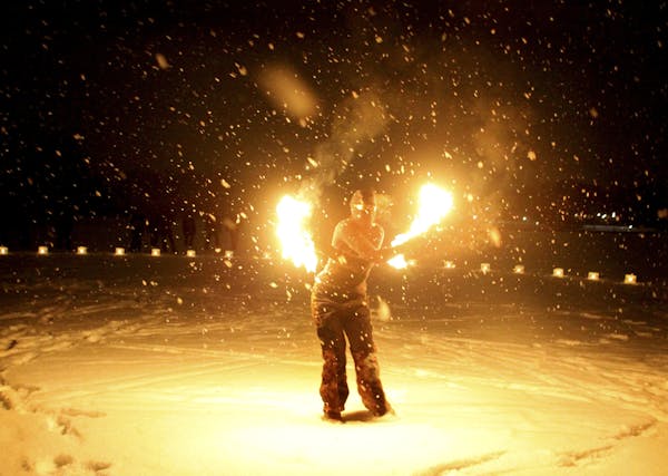Embrace the Light performer Star Williams used fire to entertain crowds of skiers. The Park Nicollet Luminary Loppet took place on Lake of the Isles o