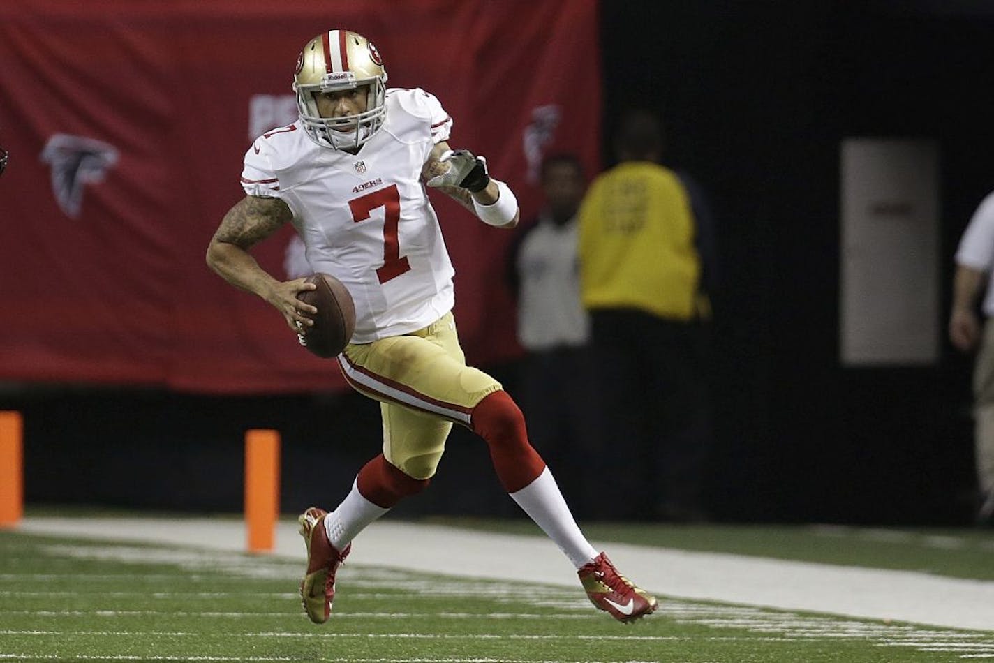 San Francisco 49ers quarterback Colin Kaepernick scrambles with the ball during the first half of the NFL football NFC Championship game Sunday, Jan. 20, 2013, in Atlanta.