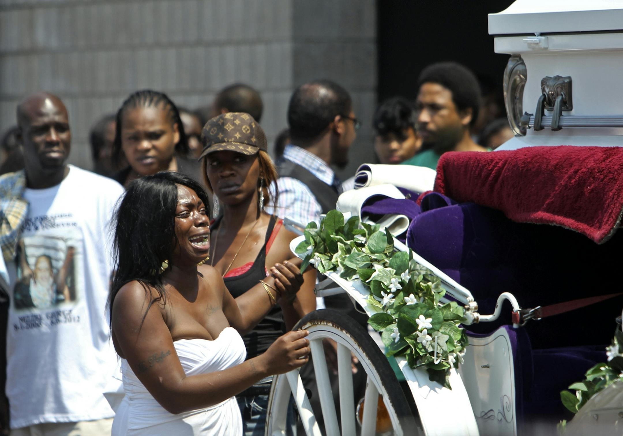 Christina Banks, left, is distraught as the horse drawn hearse holding the coffin of her son Nizzel George, 5, prepares to leave Shiloh Temple Tuesday, July 3, 2012, in Minneapolis, MN . (DAVID JOLES/STARTRIBUNE) djoles@startribune.com Funeral services were held for 5-year-old Nizzel George at Shilo Temple International Ministries in Minneapolis Tuesday.