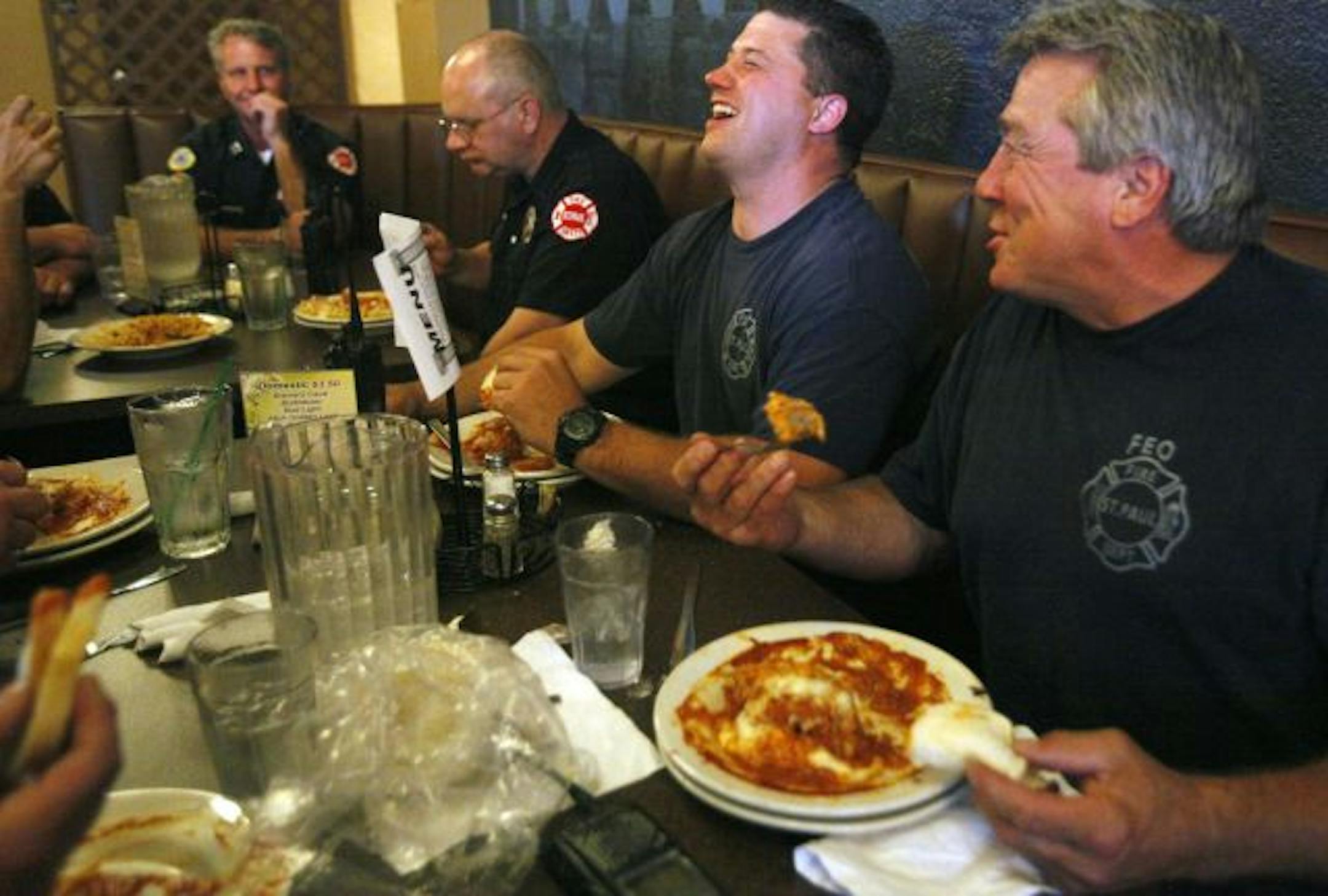 Firefighters Dennis Montanari and Anthony Farina enjoying their dinner at Yarusso's Italian restaurant.