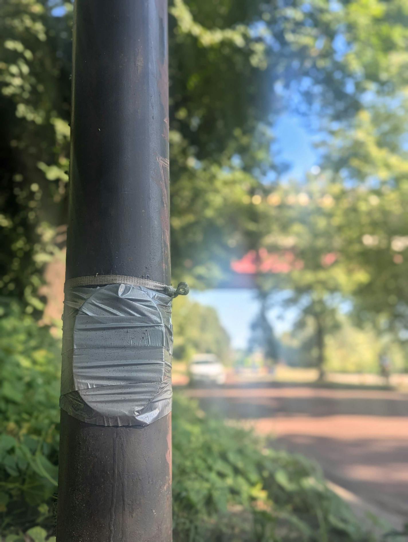 Duct tape secures a light pole along West River Road in Minneapolis.