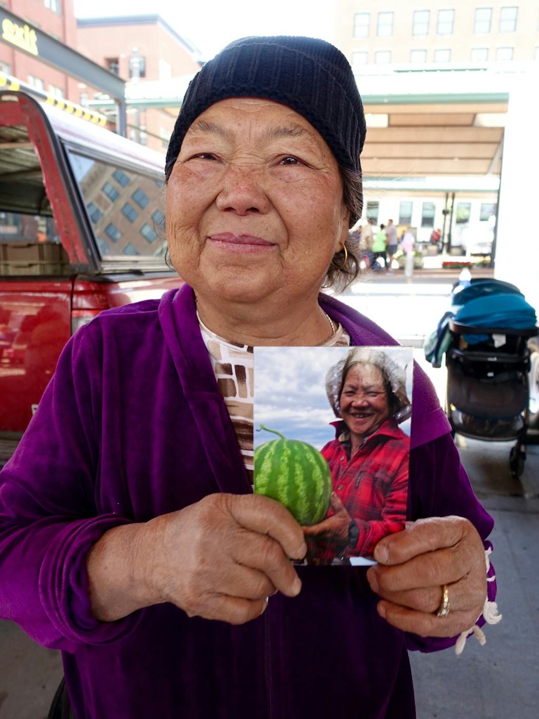 Phoua Thao Hang held a picture of her oldest sister who had grown watermelon on the HAFA farm. Phoua was killed this year in a brazen hit-and-run.
