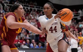 Stanford forward Kiki Iriafen (44) drives to the basket against Iowa State center Audi Crooks during the second half Sunday. One game after Crooks sco