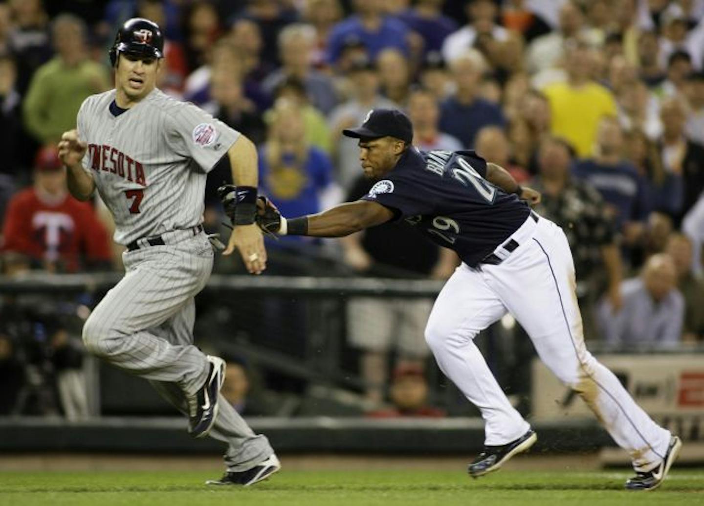 Seattle Mariners third baseman Adrian Beltre runs down Minnesota Twins' Joe Mauer for an out as Mauer tries to steal home in the 10th inning of a MLB baseball game Friday, June 5, 2009, at Safeco Field in Seattle. The Twins beat the Mariners 2-1 in 10 innings.